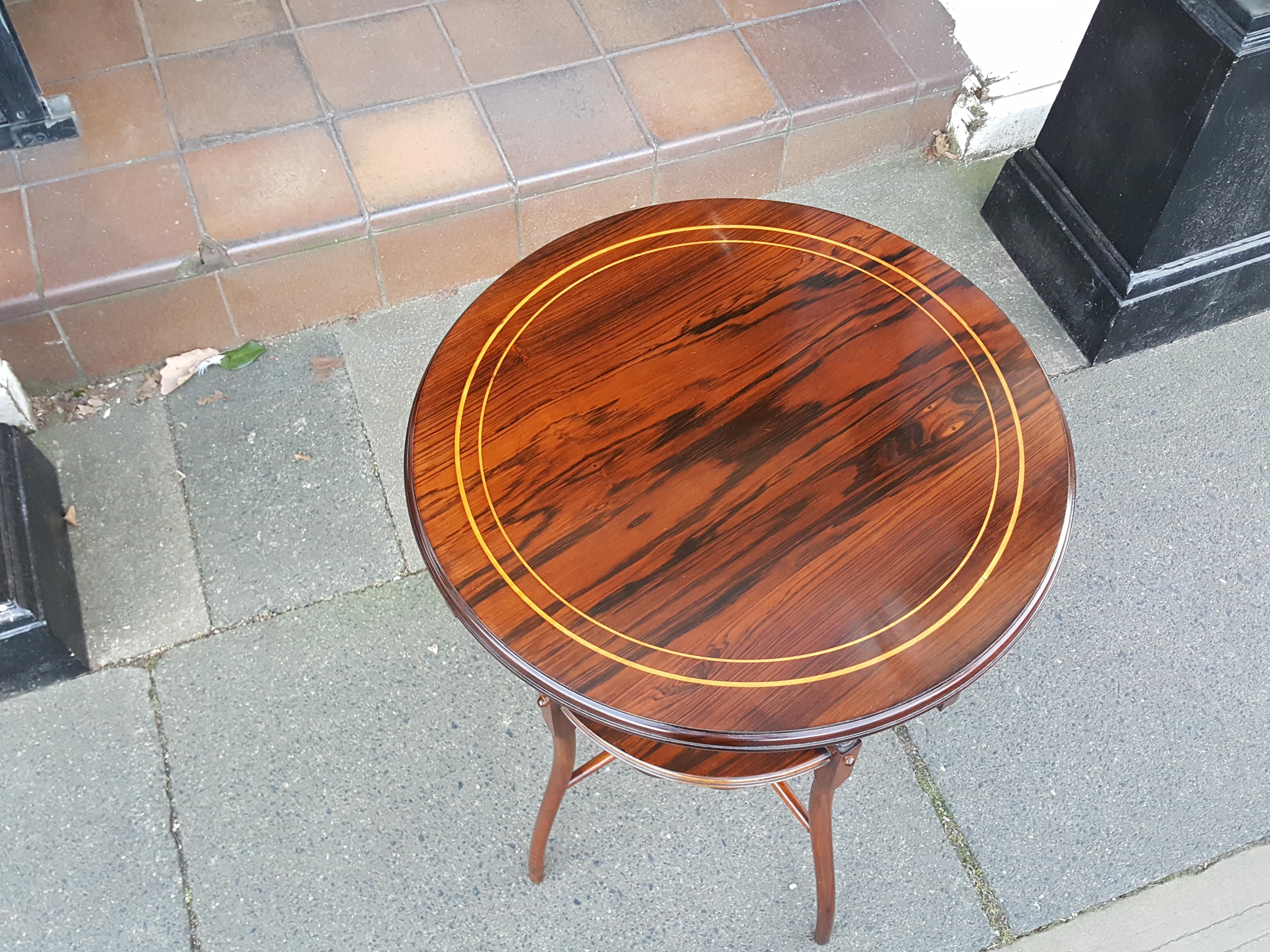Edwardian inlaid rosewood circular two-tier occasional wine table, with turned supports and low cross stretcher.
Measures: 18