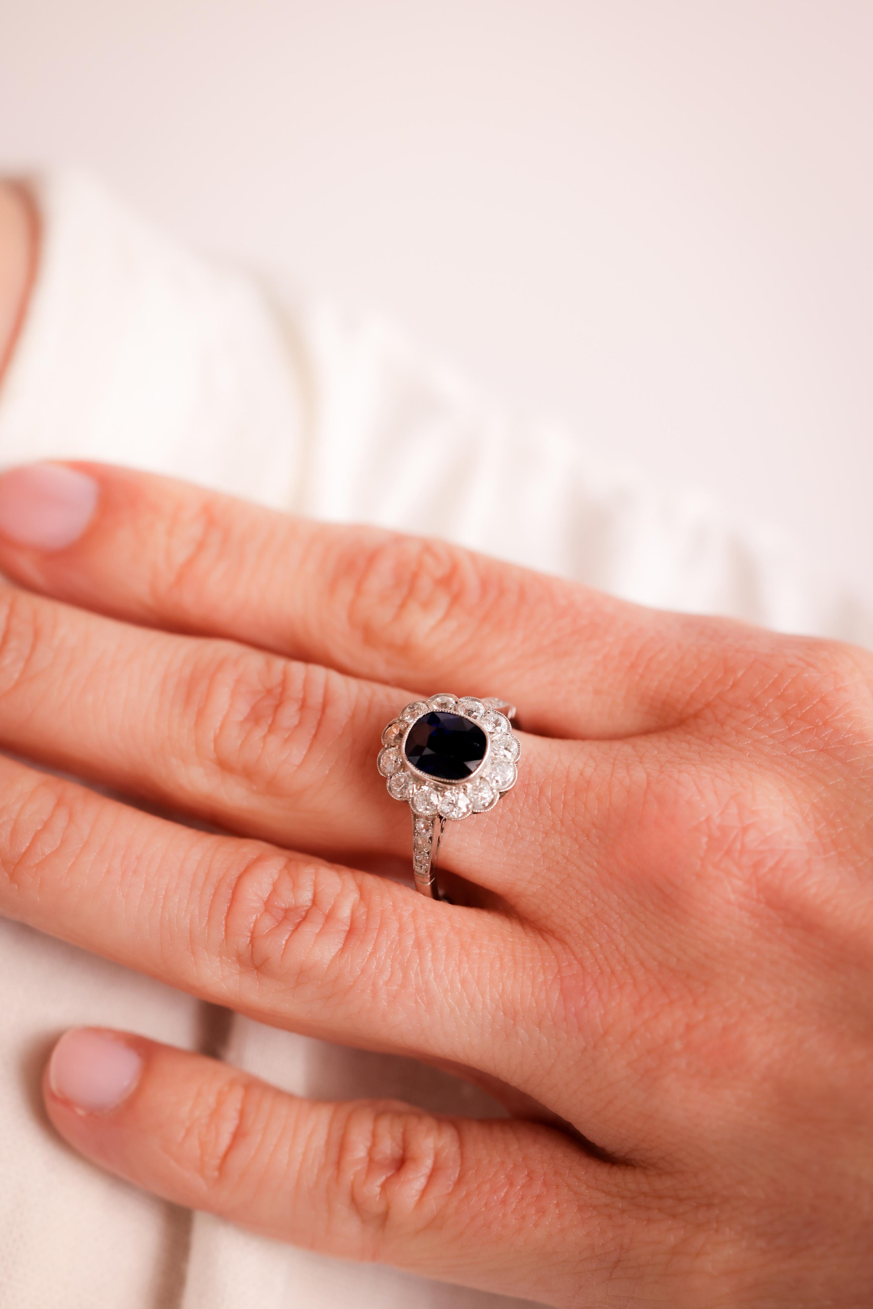 Center Stone: Sapphire
Cut: Cushion Cut
Weight: 2.06 Carat
Color: Deep Blue
Accent Stone: 18 Diamonds
Cut: Old European Cuts
Weight: Approximately 1.2 Carats
Color: H
Clarity: VS
Metal: Platinum
Era: Modern
Circa: 2020's in the Style of