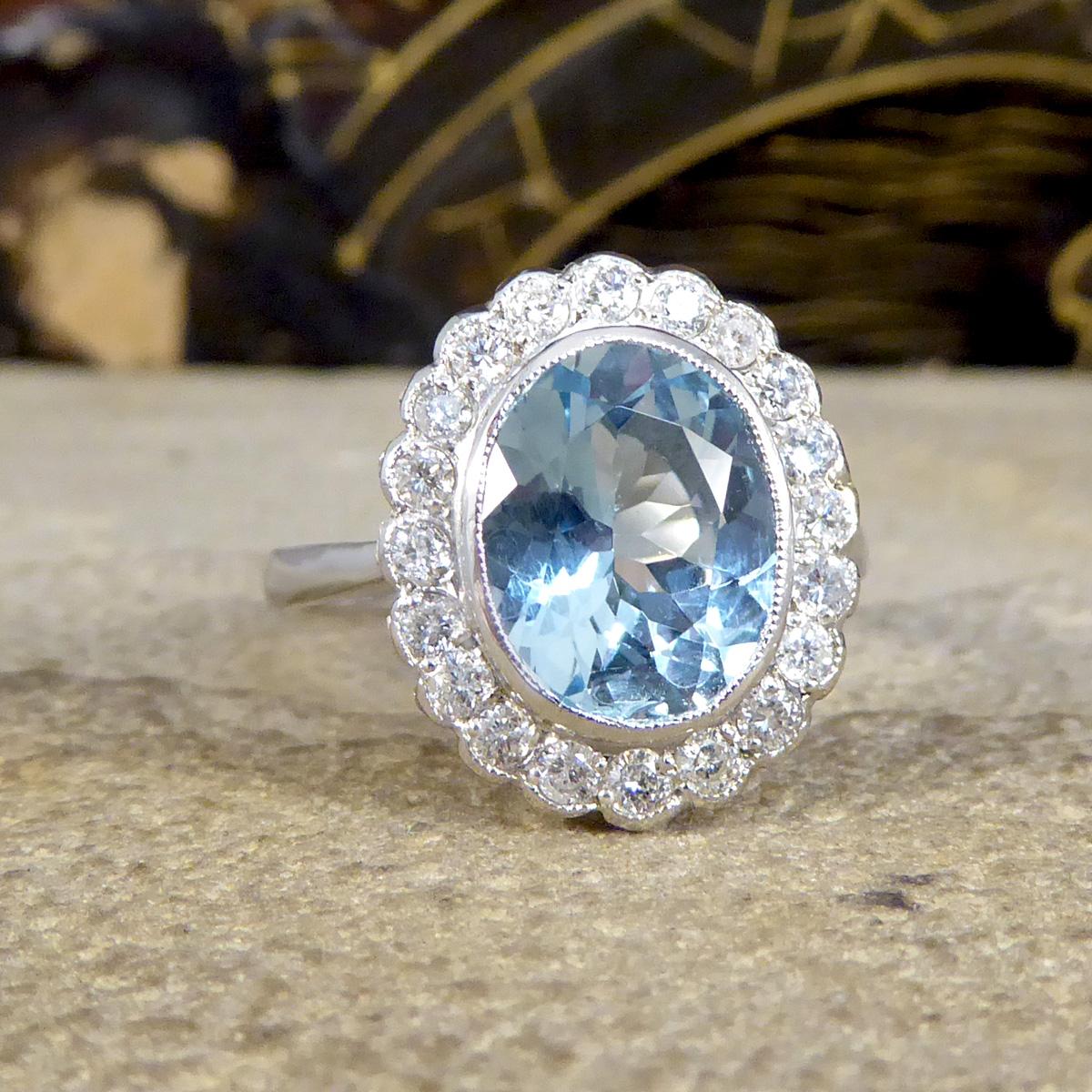 This contemporary has been designed to resemble an Edwardian piece with its milgrain detailing and basket setting. This ring holds a beautifully blue oval cut Aquamarine in the centre in a bezel setting weighing 2.25ct with a surround of 20 Modern