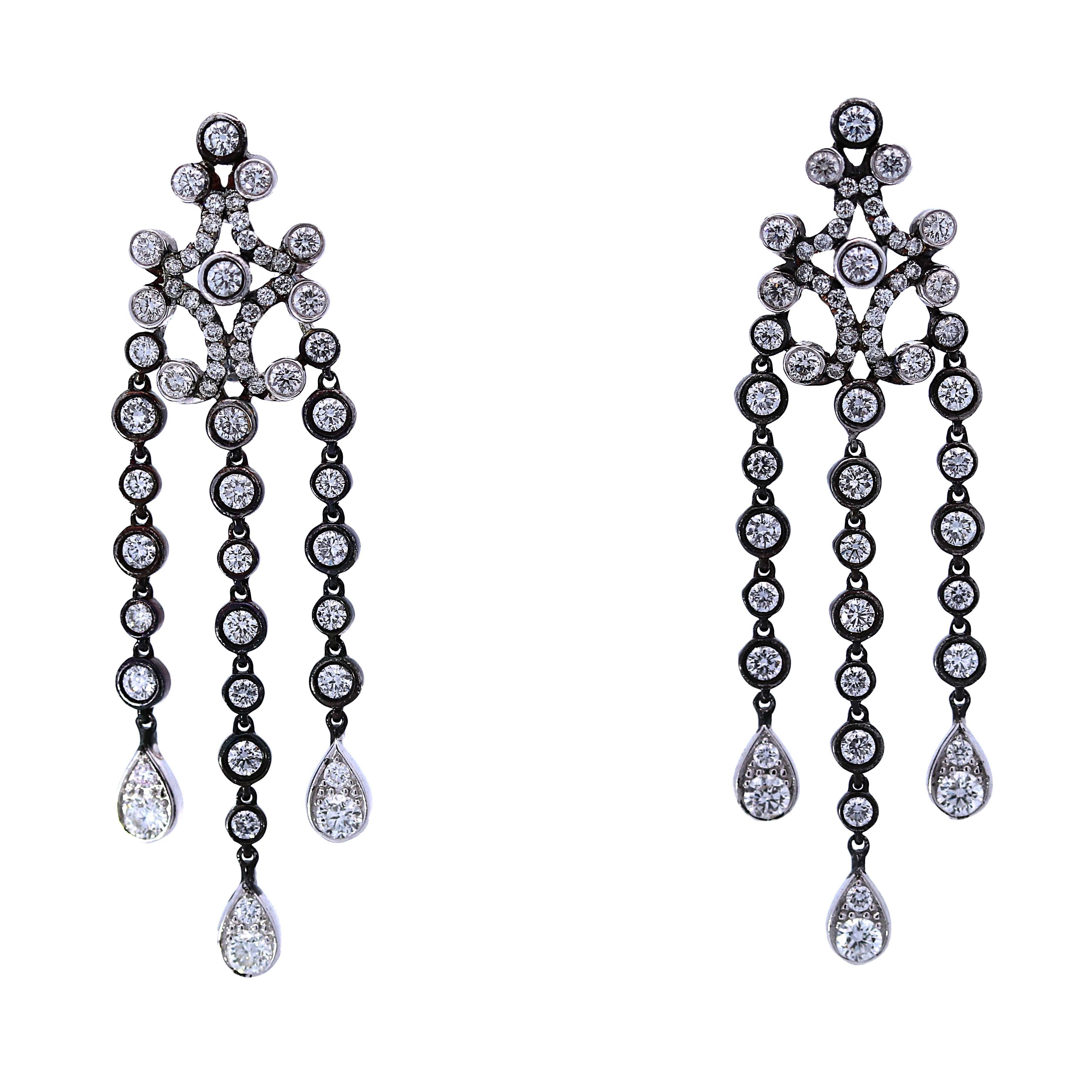 Belle Époque inspired diamond dangle drop chandelier earrings. Crafted with precision and adorned with a mesmerizing cascade of diamonds totaling 3.01 carats, each earring embodies sophistication and allure. Set in luxurious 14-karat white gold with