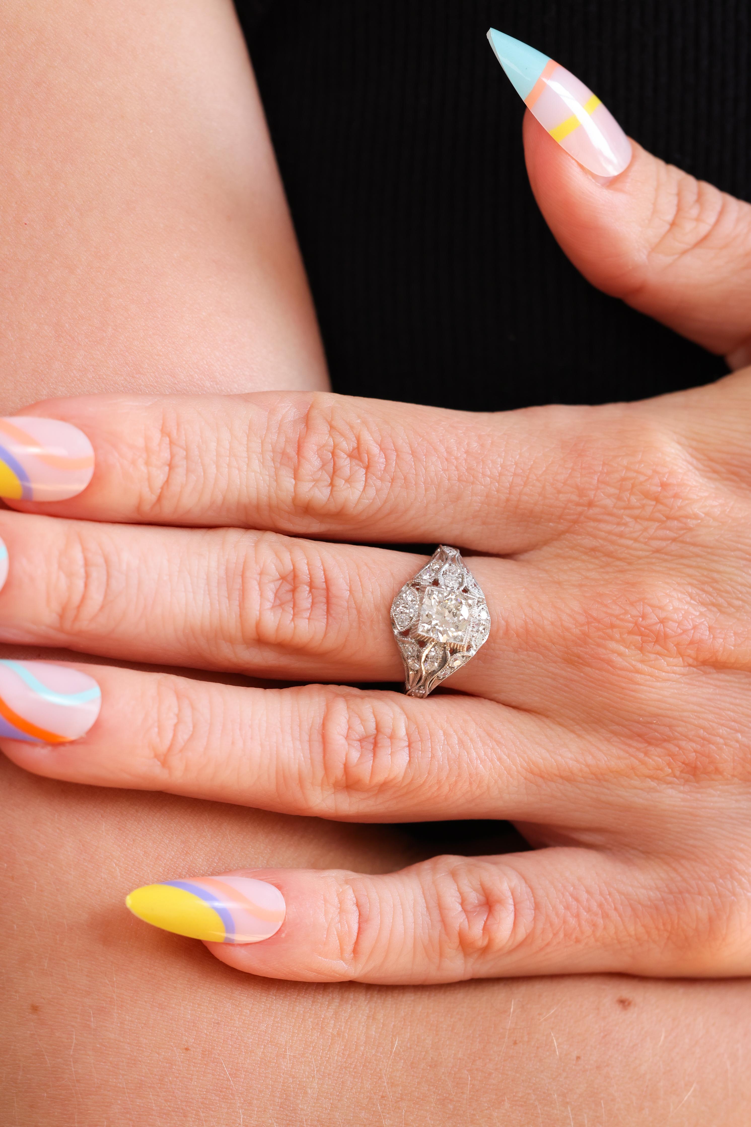 This is a beautiful Trumpet & Horn Edwardian-inspired platinum diamond engagement ring that is handcrafted by our master jeweler in downtown Los Angeles! A sparkling box set certified 0.93ct Round Brilliant Cut diamond centers this beautiful