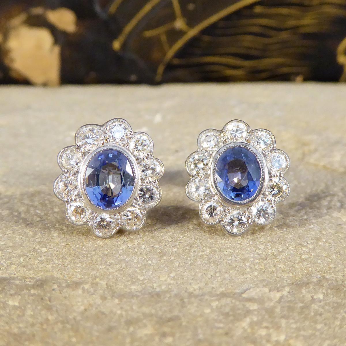 Embrace the elegance of a bygone era with these stunning Edwardian-inspired stud earrings, beautifully crafted in 18ct Yellow and White Gold. Each earring features an exquisite oval sapphire, known for its deep, mesmerising and bright blue colour,