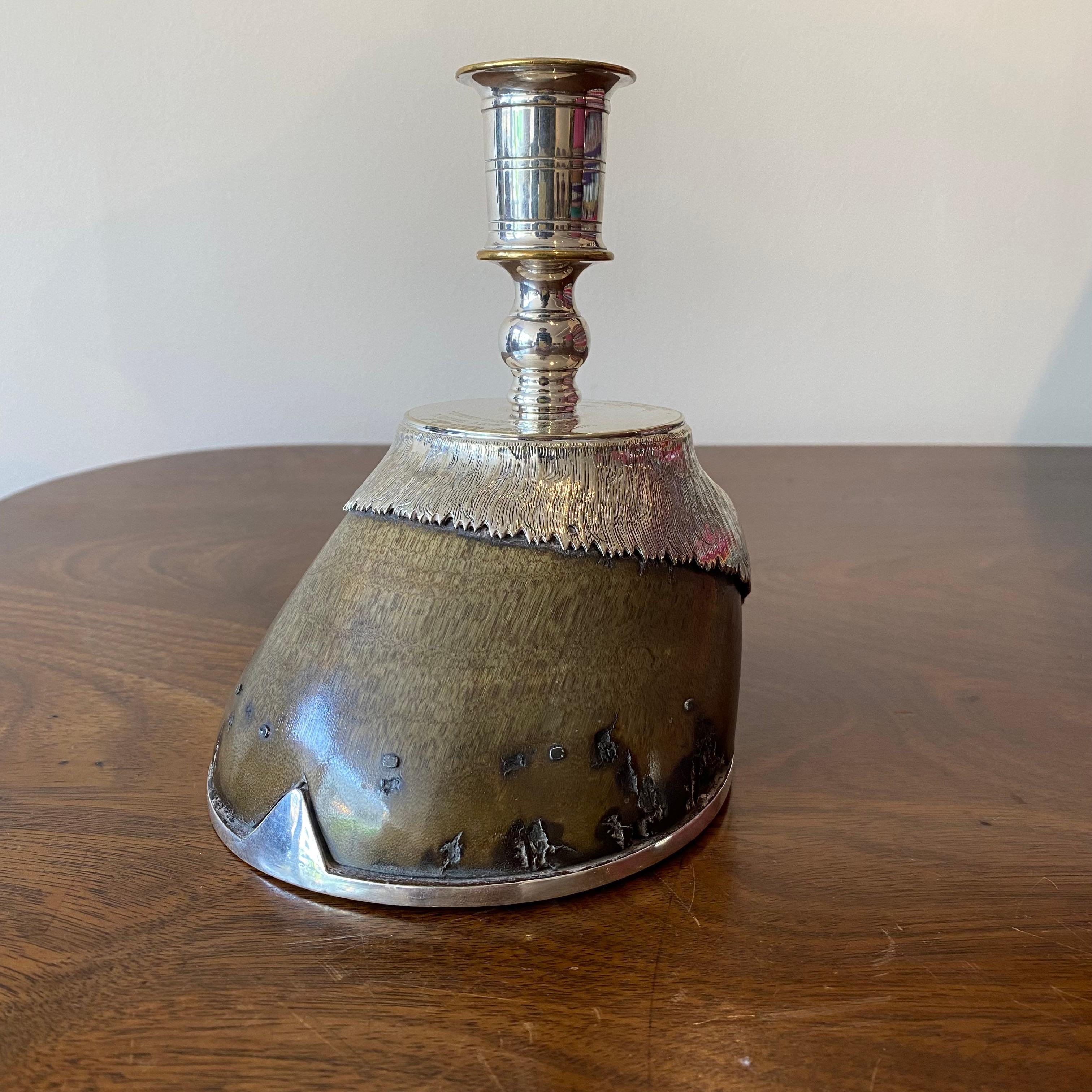 A beautiful horse hoof candlestick with silver plate embellishment. 

The piece has been mounted by Rowland Ward and has the makers stamp of 'Rowland Ward Limited, 166 Piccadilly' to the horse shoe.

The upper section has the following