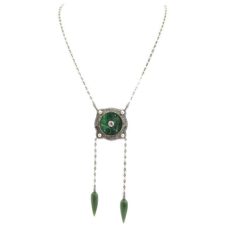 This unique and amazingly well handcrafted Edwardian soutoir, from ca.1910 is a true piece of most wearable art. The center piece, a disc of carved jade is bezel-set in a platinum frame with fine milligrain around the top. In the center of the jade