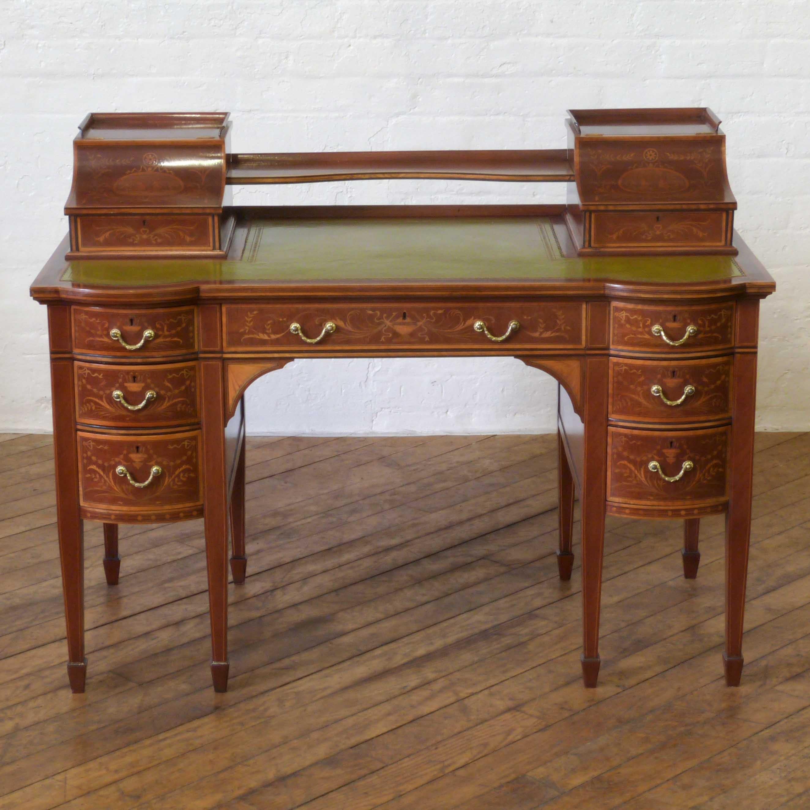 This is a wonderful mahogany desk by the highly regarded cabinet makers Edwards and Roberts. Profusely inlaid, crossbanded and string lined to all sides and designed on the lines of a scaled down Carlton house desk of exquisite quality and