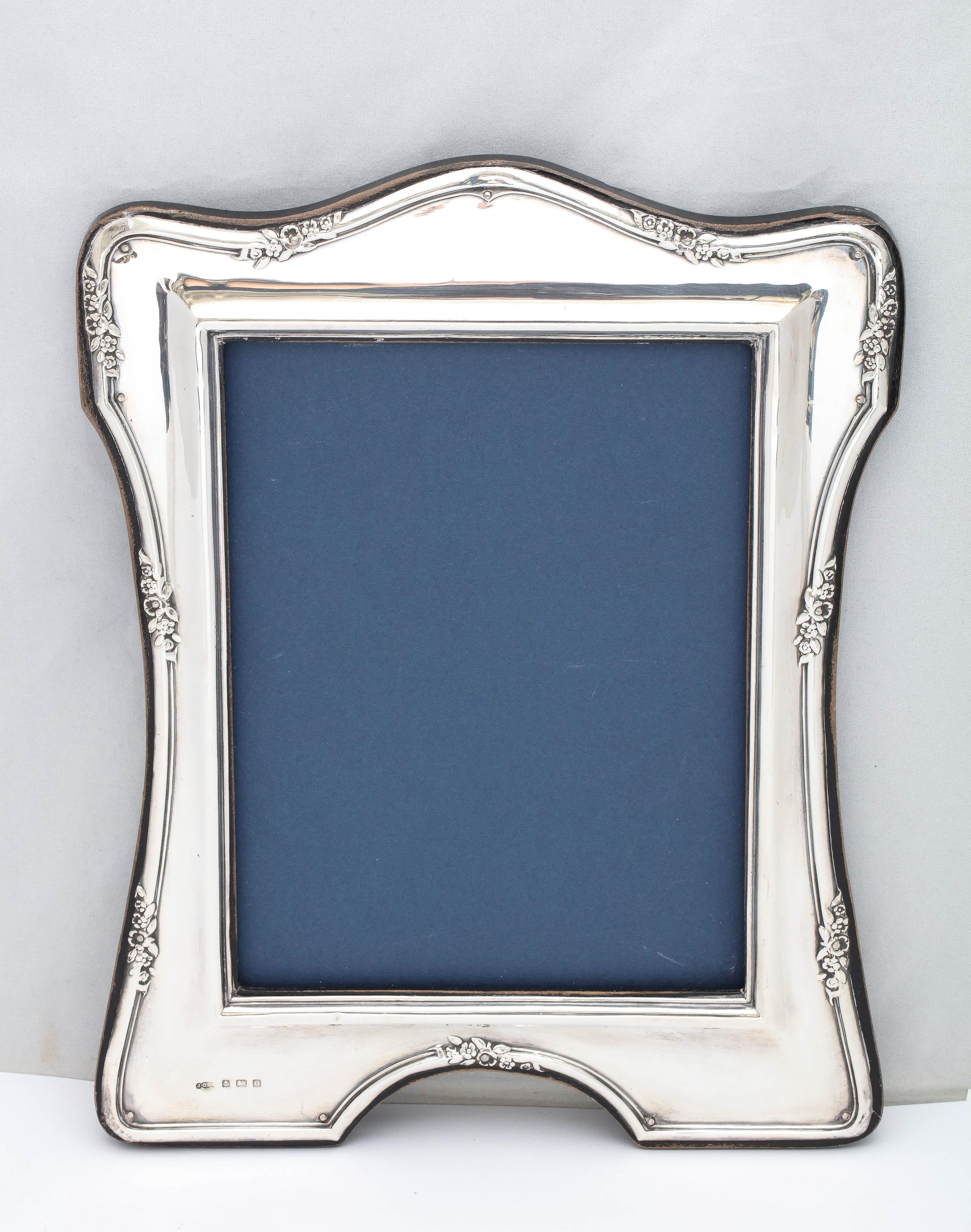 Large, sterling silver wood-backed picture frame, Birmingham, England, year-hallmarked for 1913, Joseph Gloster, Ltd. - makers. Measures 12 inches high (at highest point) x 9 1/4 inches wide (at widest point) x 5 inches deep when easel is in open