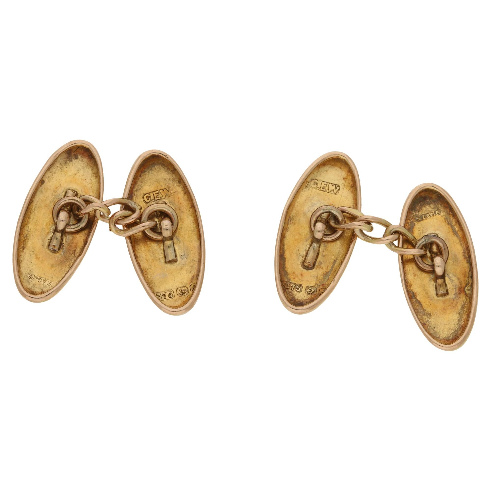 A pair of antique rose gold cufflinks, detailed with a leaf pattern. 
Makers mark 'C.E.W.', hallmarked Birmingham, 375, dated 1903.  
On a five link chain fitting.