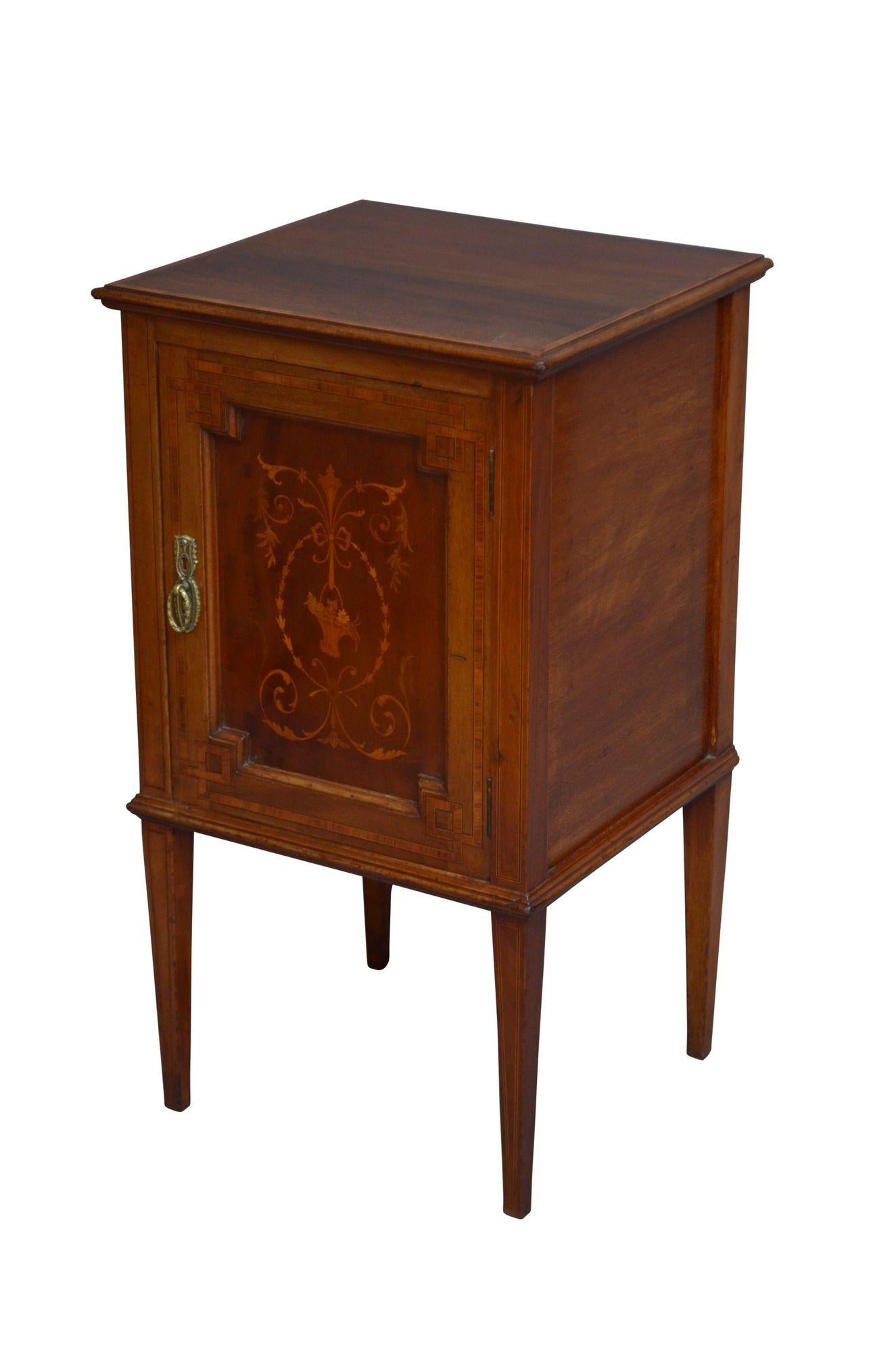 K0302 Attractive Edwardian bedside cupboard in mahogany, having figured mahogany and inlaid top with moulded edge above satinwood crossbanded and inlaid panelled door fitted with original brass handles, all standing on inlaid tapered legs. This