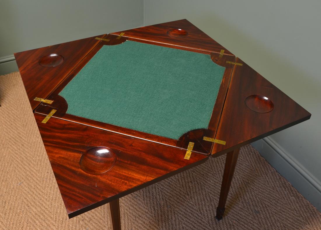 Quality Edwardian mahogany antique envelope card table

This quality Edwardian mahogany antique envelope card table, circa 1900 is a very unique design with a beautifully figured top with crosssbanded satinwood edge. The top swivels and four