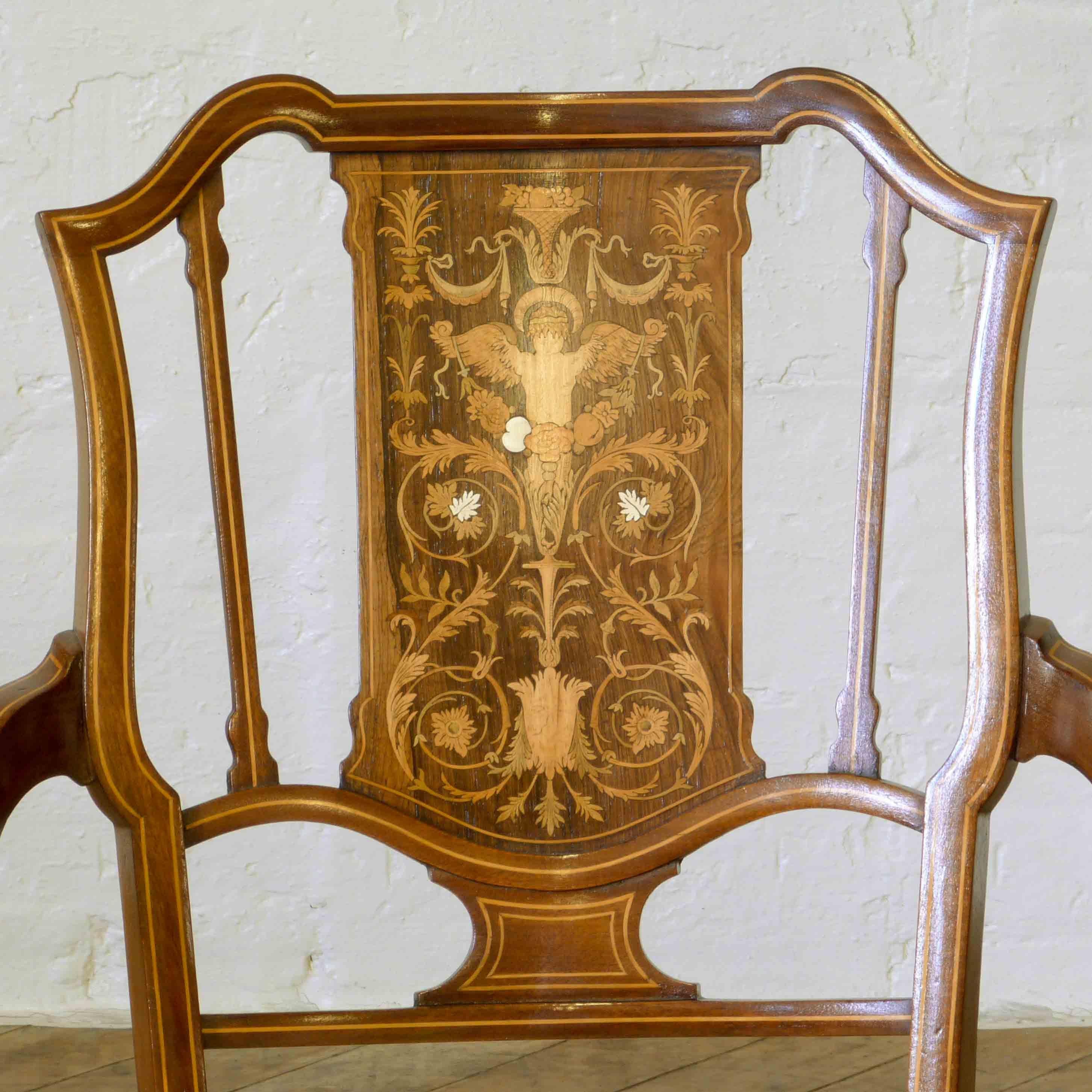 An exquisite mahogany armchair, lined throughout with boxwood stringing and highlighted with a profusely inlaid panel to the back. Repolished and newly upholstered in a gold damask material, this chair is back to it's best and ready to admire and
