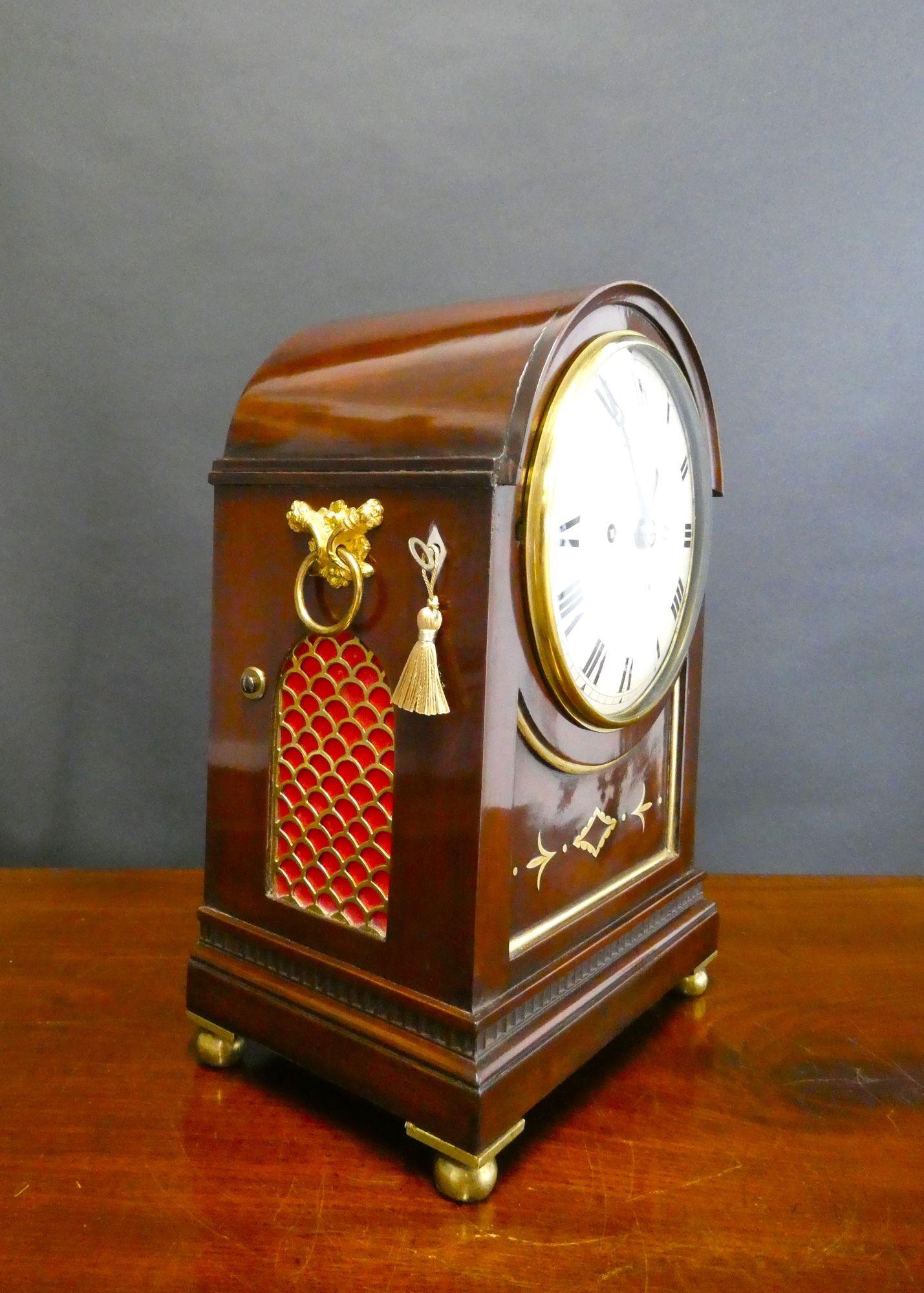 Edwardian Double Fusee Bracket Clock, Dent, London

Edwardian bracket clock housed in a mahogany arch top case with inset front panel banded in brass with brass inlay, stepped plinth with dentil moulding decoration resting on four brass ball feet.