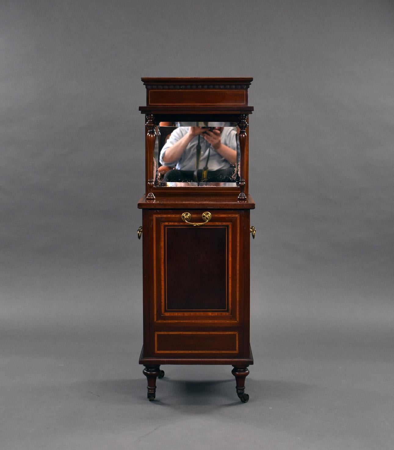 Edwardian Mahogany Coal Purdonium in good condition with mirror back to the top with elegant spindles to the front and banded inlay to the front and sides, with carrying handles to each side. The front pulls down to reveal the original coal box and