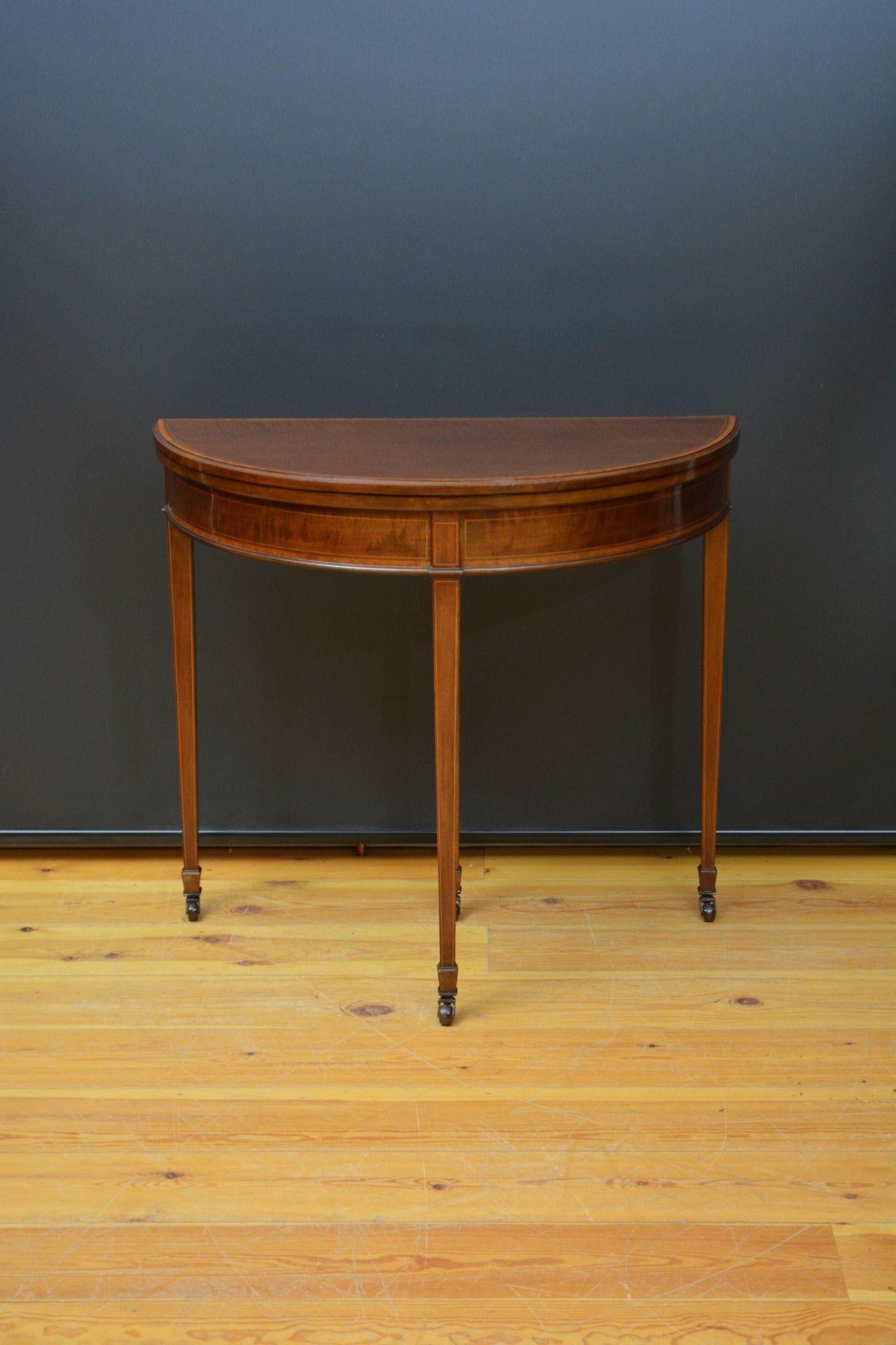 Sn5615 Fine quality and very elegant Edwardian half moon fold over card table / console table, having figured mahogany top with satinwood crossbanded and moulded edge which opens to reveal newly lined baize surface all above string inlaid frieze,