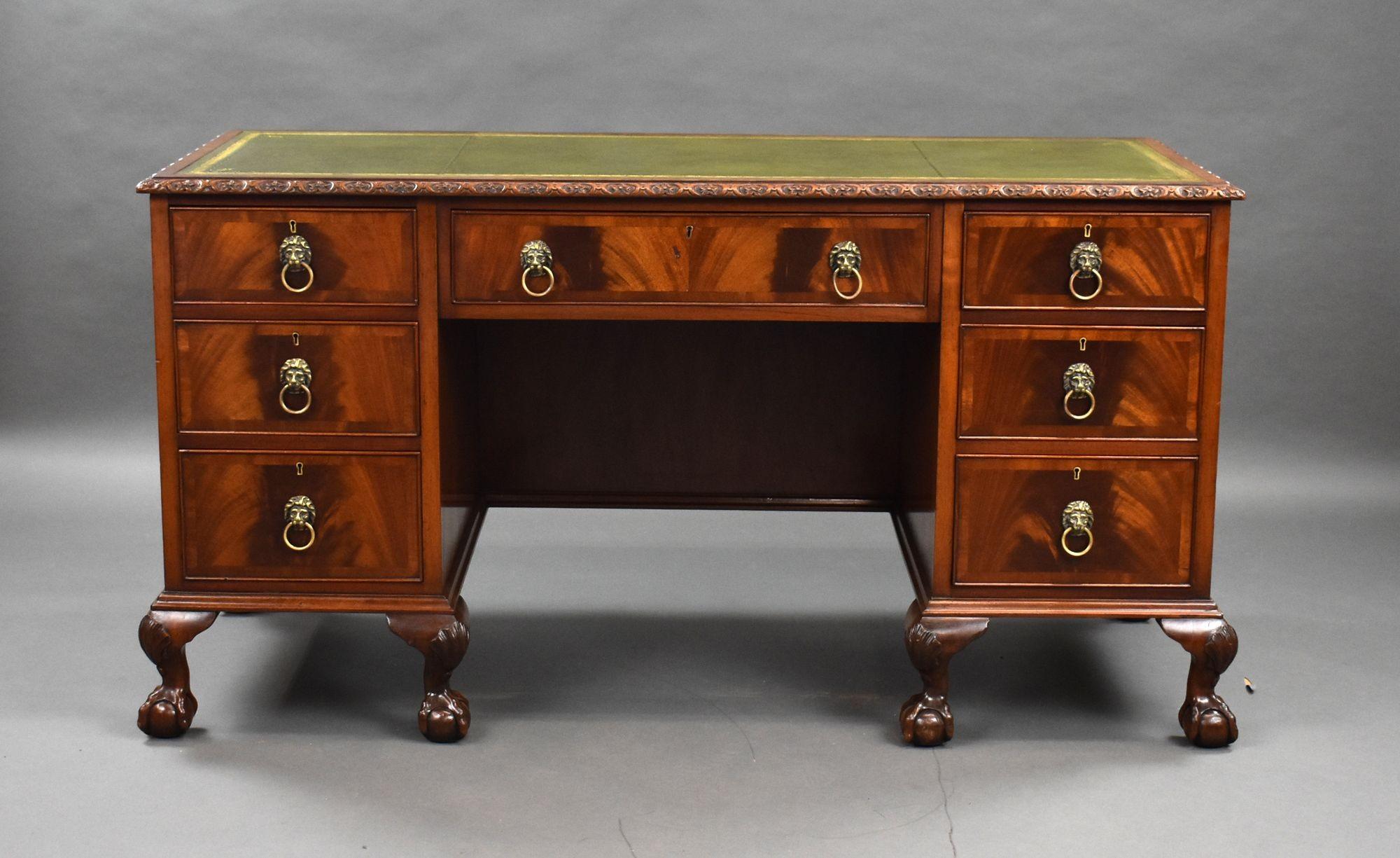 For sale is a good quality Edwardian mahogany desk, having an inset green leather top, decorated with gold tooling, above an arrangement of seven drawers, each with brass handles, raised on claw and ball feet, the desk is in very good condition for