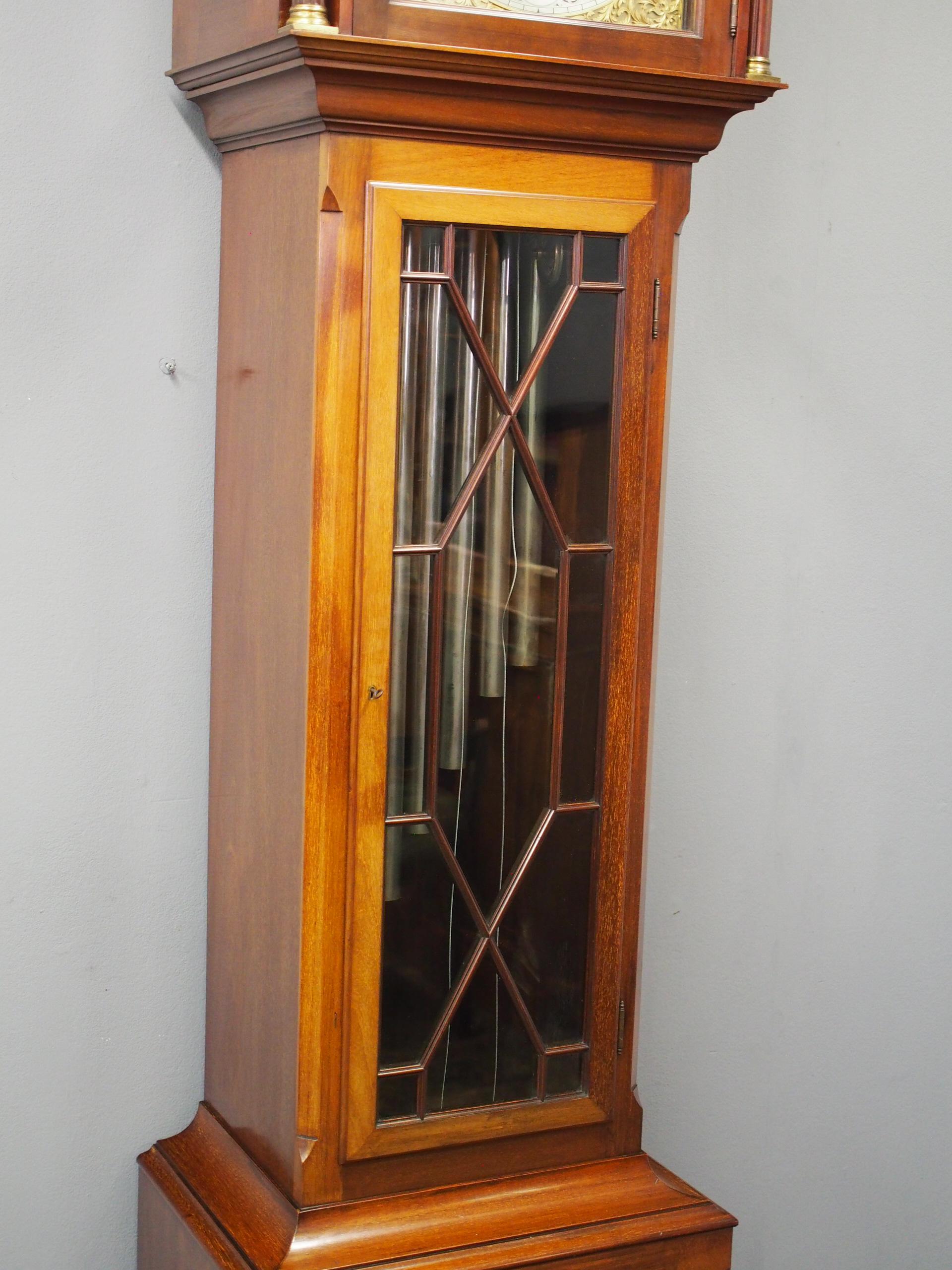 Edwardian mahogany grandfather clock with chimes, bearing the name James Ramsay of Dundeen circa 1900. The arched hood and silverised brass face have Roman numerals with exquisite engraved brass fretwork. It also has a series of dials to the face,