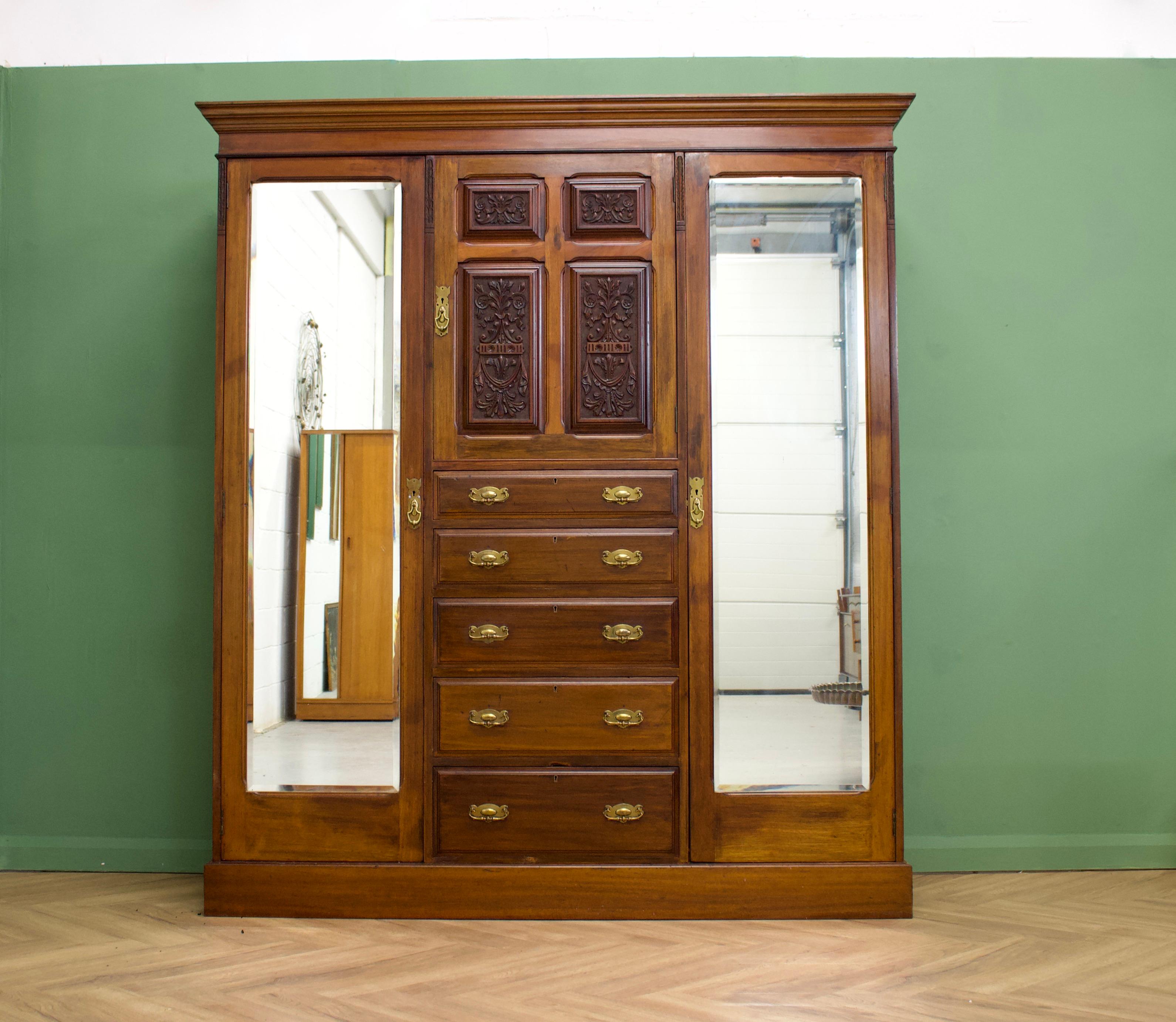 A large Edwardian mahogany compactum - Perfect to use as a freestanding hall cupboard or boot room cabinet - it can also be used as a wardrobe by adding rails to each side compartment
There are two full length hanging compartments with hanging