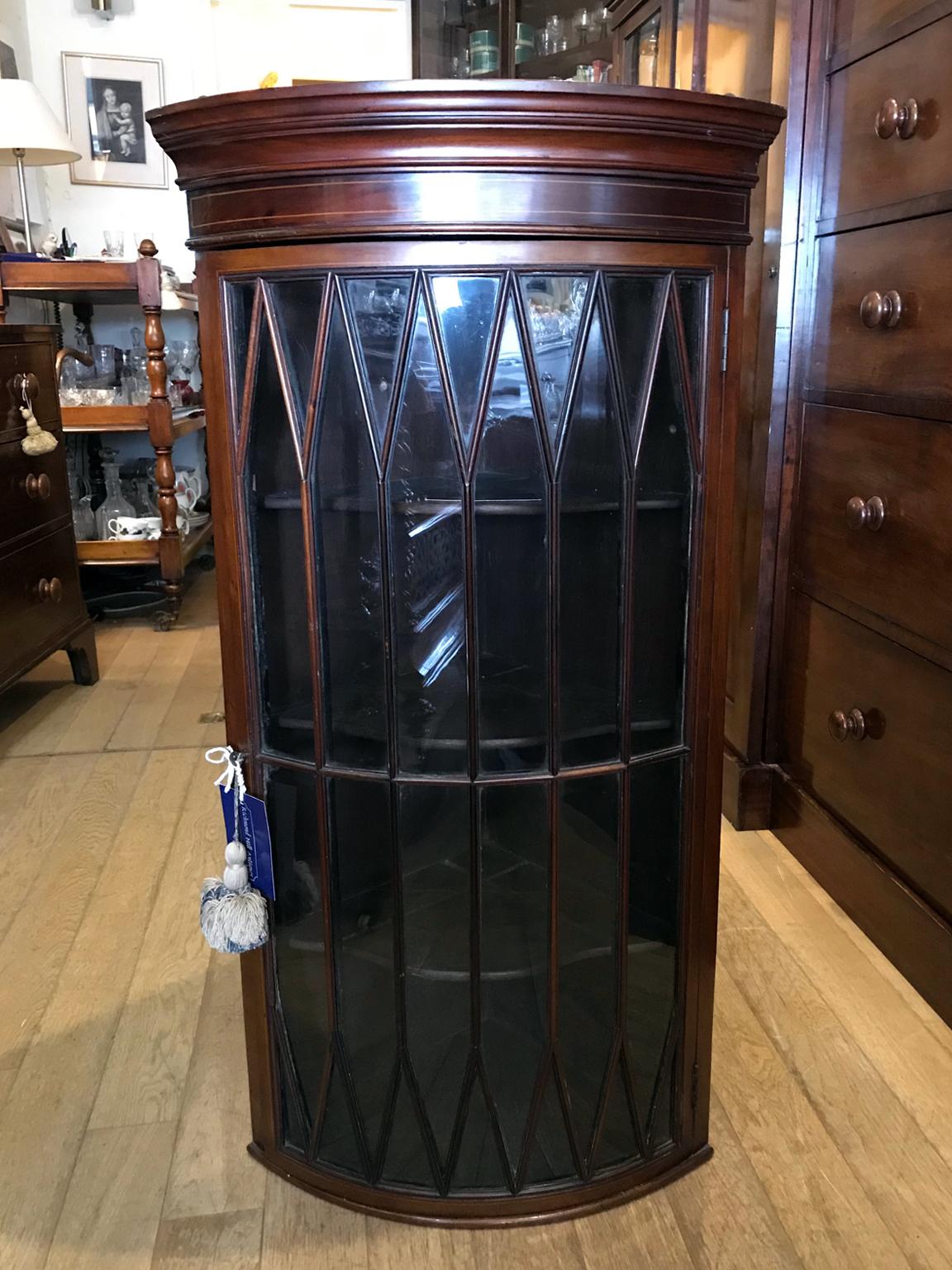 Early Edwardian mahogany inlaid bow shaped hanging corner cupboard with original astral glass and four shelves on the inside,

circa 1900.

Dimensions:
Height 40 inches - 102 cms
Sides 15 inches - 38 cms.

 