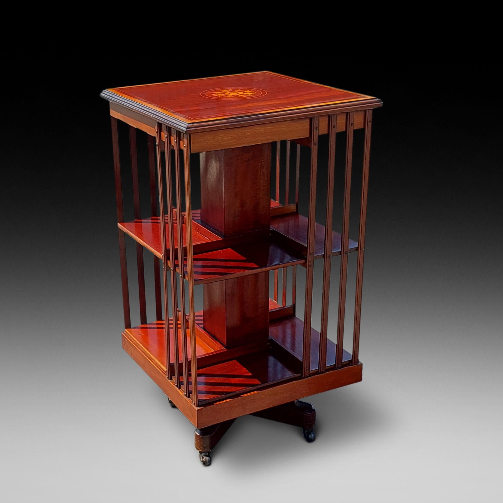 Edwardian Mahogany Inlaid Revolving Bookcase, with two tiers, rotating superstructure raised on castors. 18.5