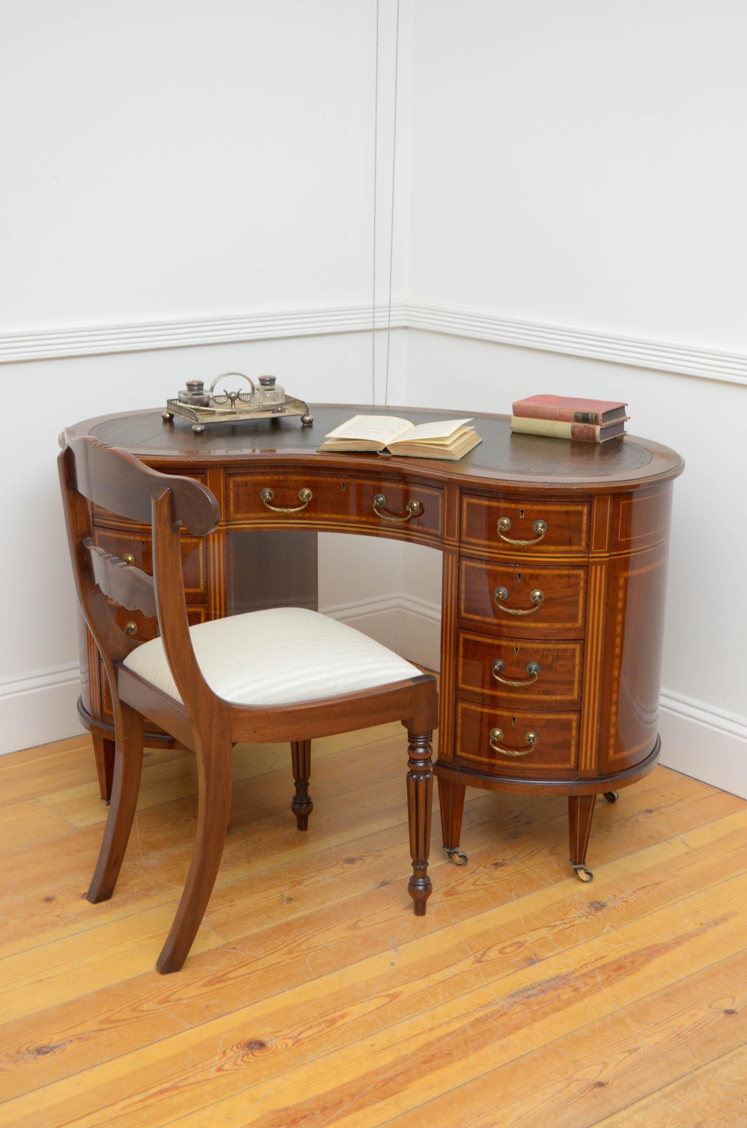 Sn4703 fine quality Edwardian, mahogany, kidney shaped writing desk, having tooled leather writing surface, above a concave centre drawer flanked by 8 satinwood crossbanded and mahogany lined, graduated drawers fitted with brass handles, all