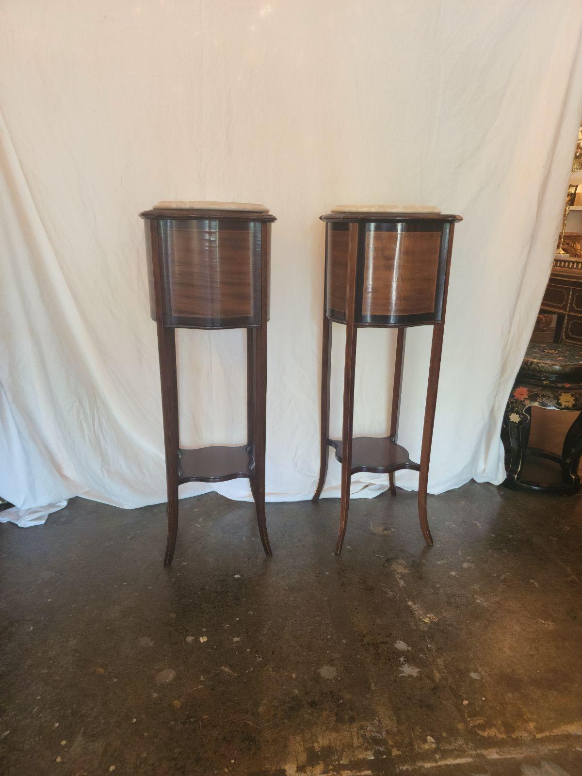 Elegant Antique Edwardian Mahogany and marble jardiniere or plant stand, circa 1905 In a Sheraton Revival Design, It has Ebonised serpentine shape sides with chequered inlay. Matching Pair.