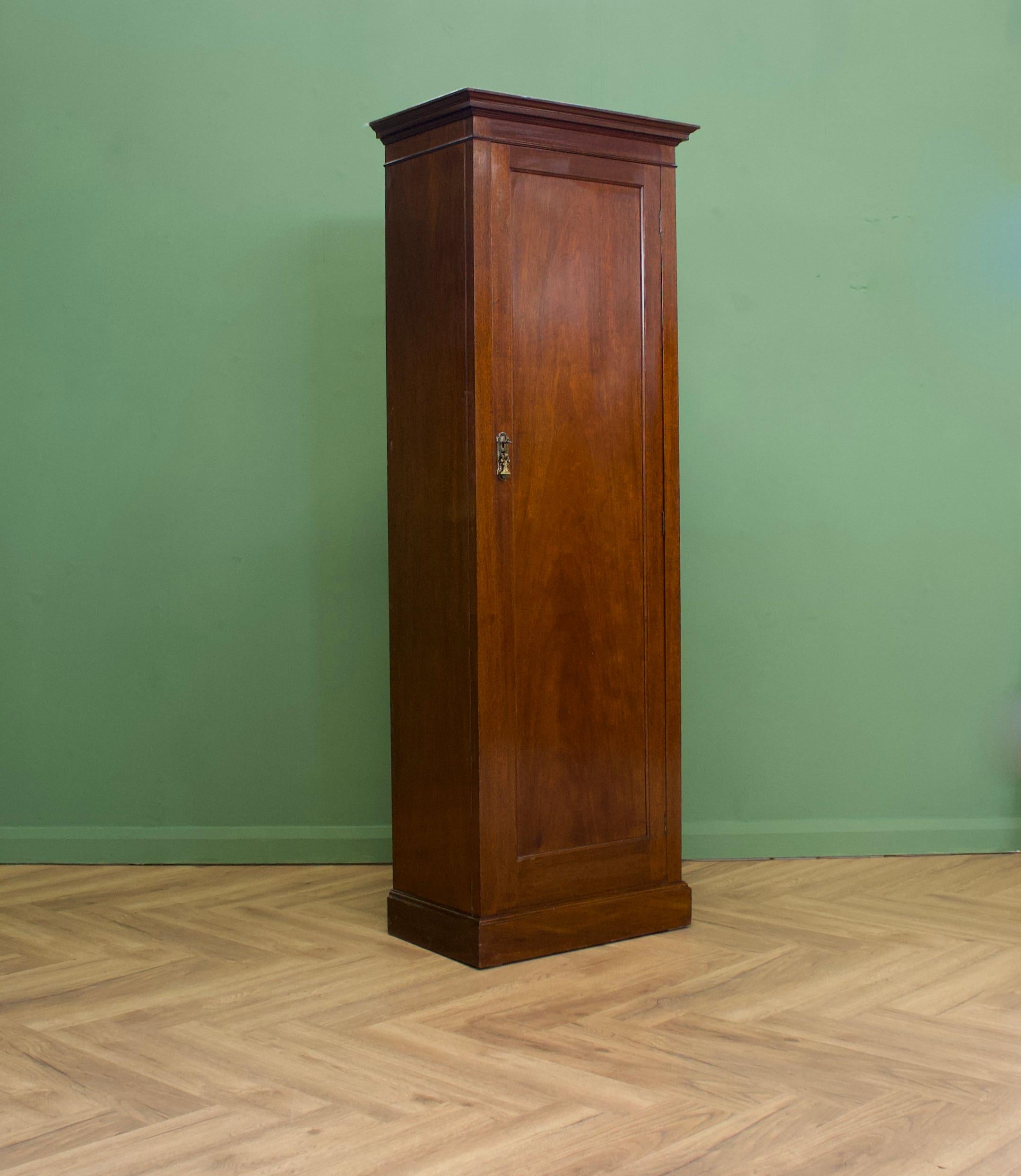 A narrow Edwardian mahogany wardrobe or hall cupboard

Featuring a rail and hooks.