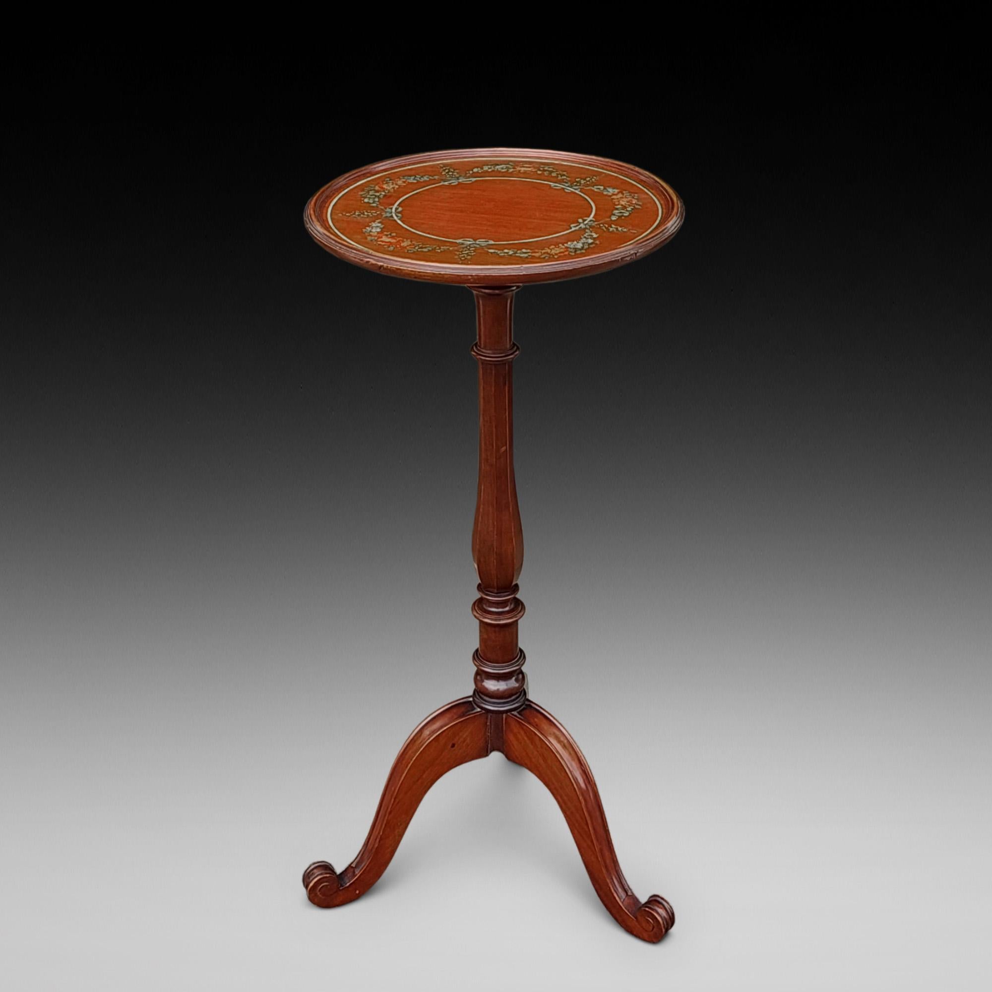 George III style mahogany candle stand or wine table, early 20th century, the circular top with a moulded rim applied with floral swags, upon an octagonal baluster column, three down swept supports and scrolled toes - 12