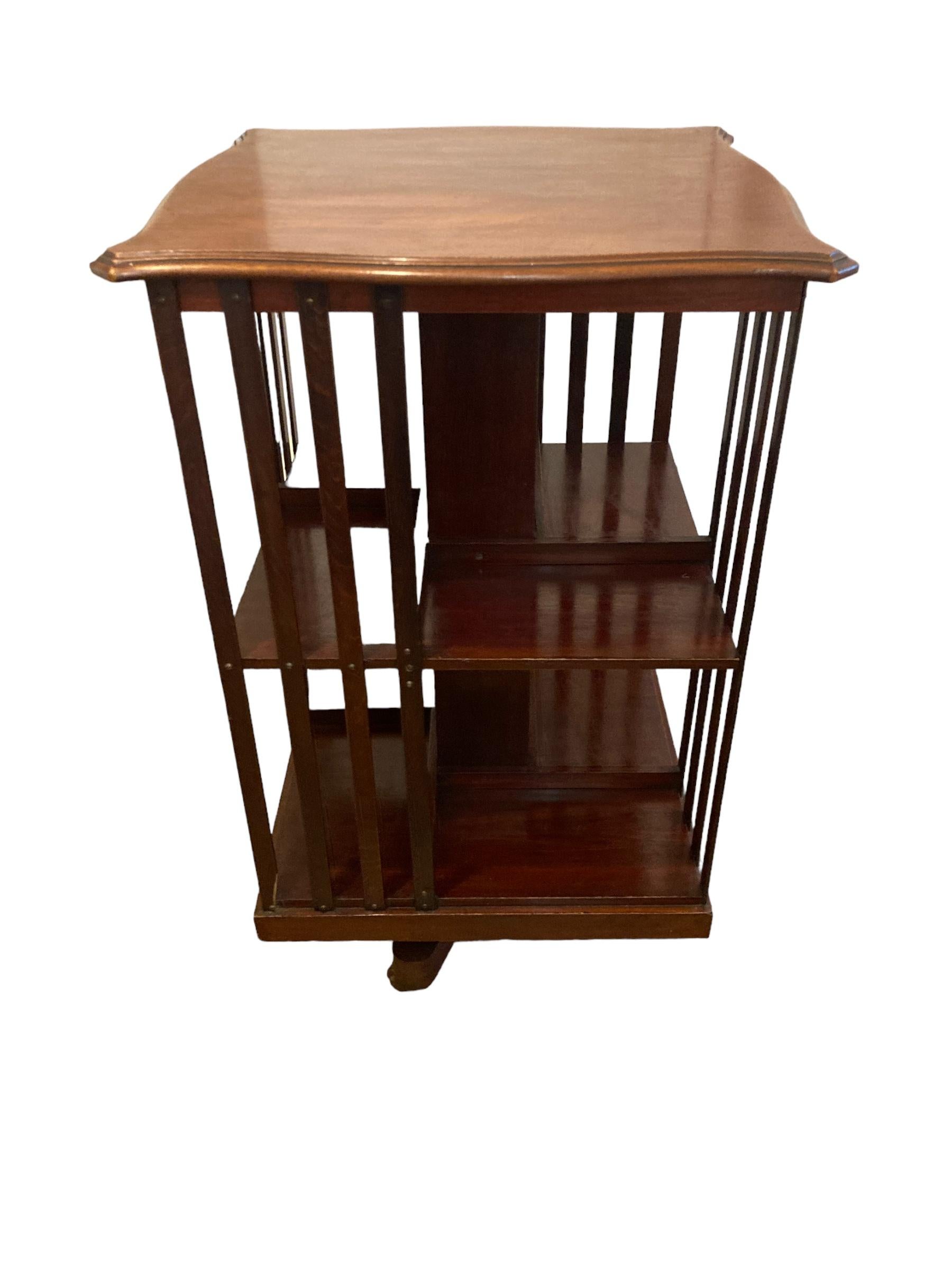 British Edwardian Mahogany revolving Bookcase on casters and slatted supports.