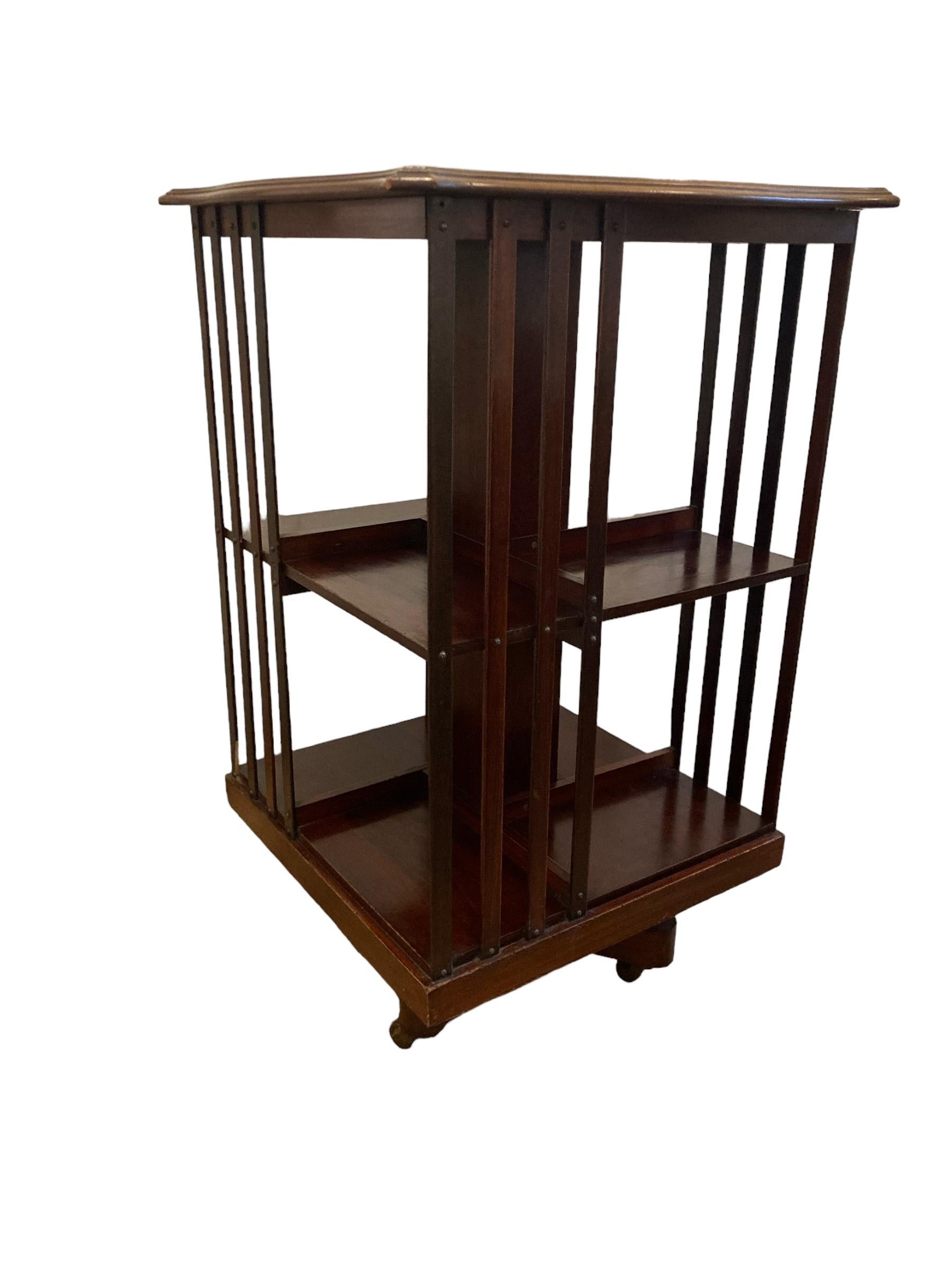 19th Century Edwardian Mahogany revolving Bookcase on casters and slatted supports.