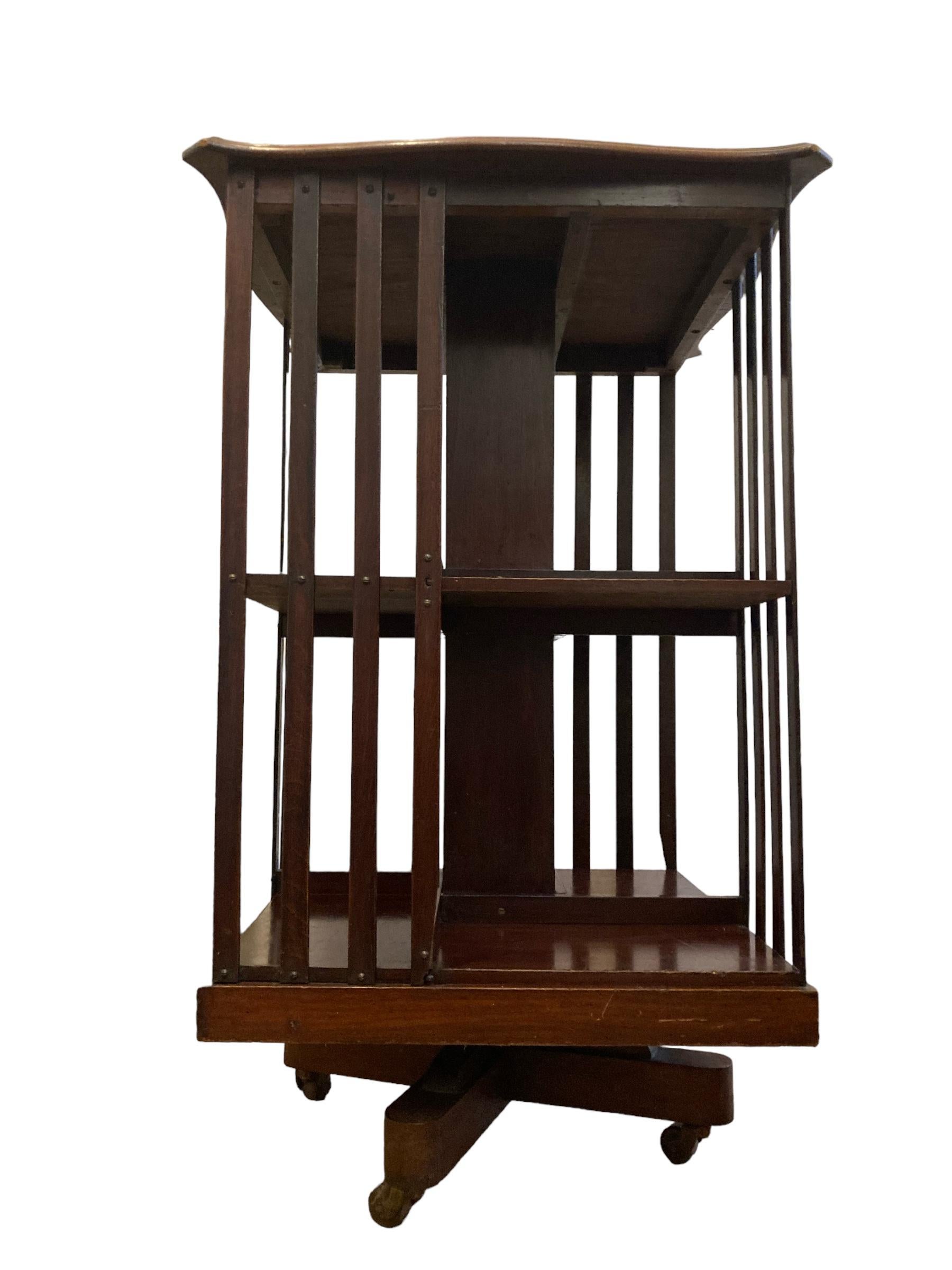 Edwardian Mahogany revolving Bookcase on casters and slatted supports. For Sale 2