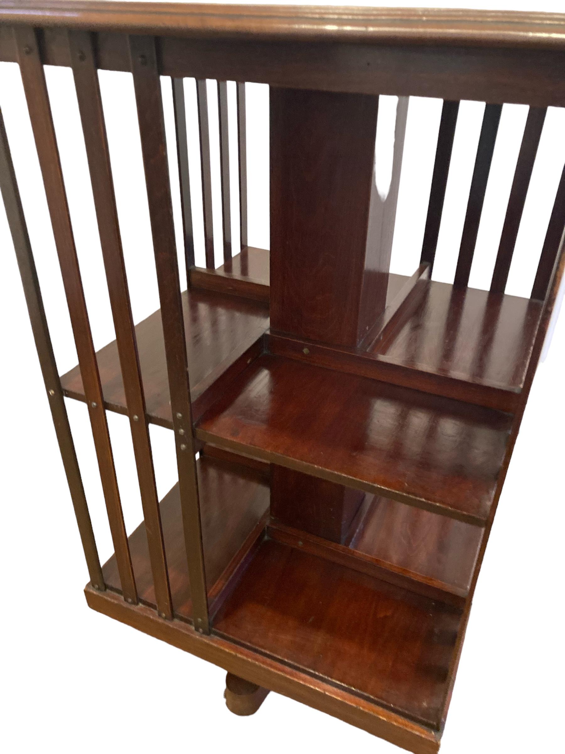 Edwardian Mahogany revolving Bookcase on casters and slatted supports. For Sale 3