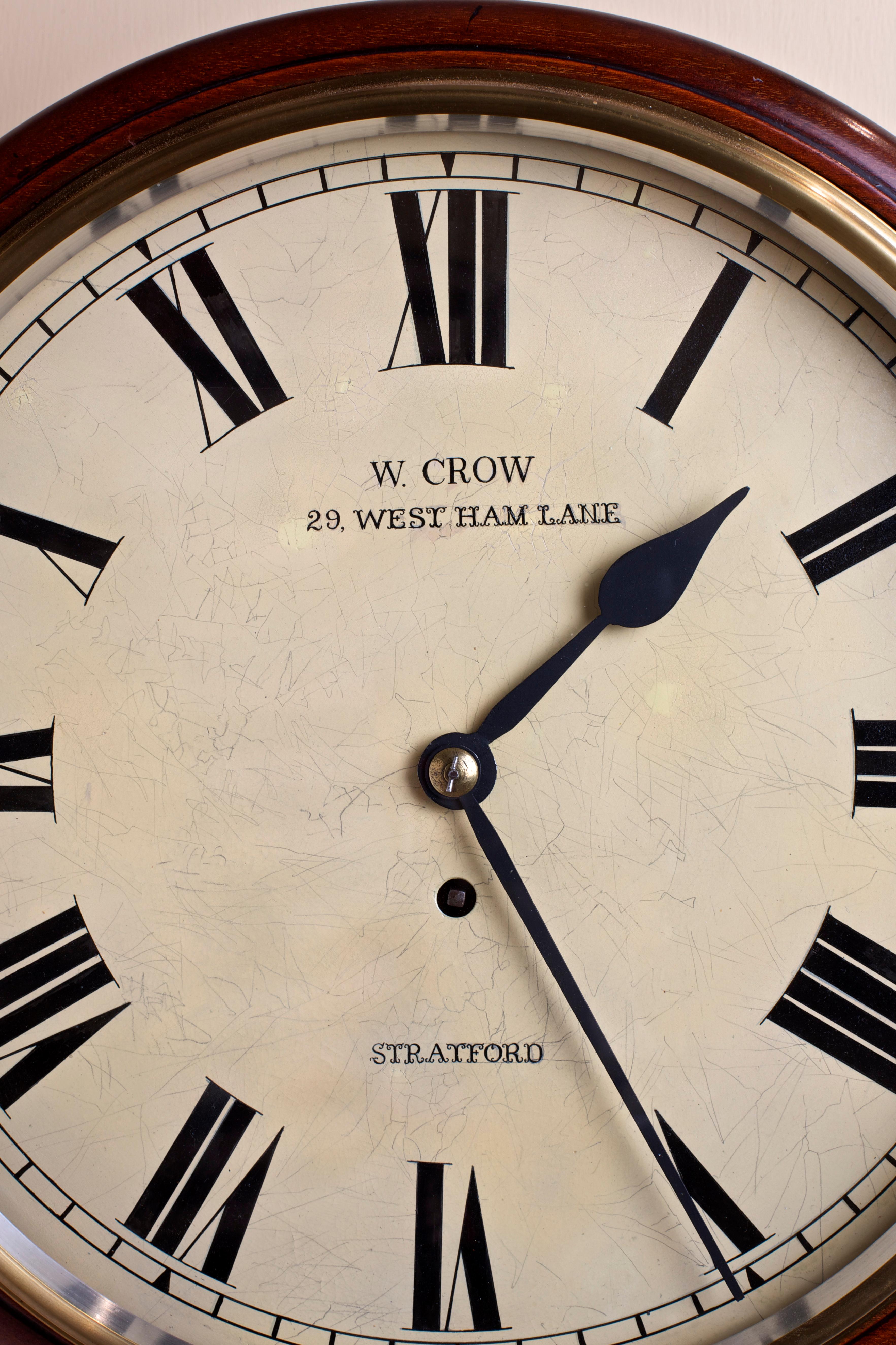 Edwardian mahogany round dial clock, painted dial with Roman numerals signed W.Crow, 29, West Ham Lane, Stratford. Eight day fuse movement.

The case also bears its original sale label from ‘W.Crow. Watch and clock maker, jeweler and optician’.