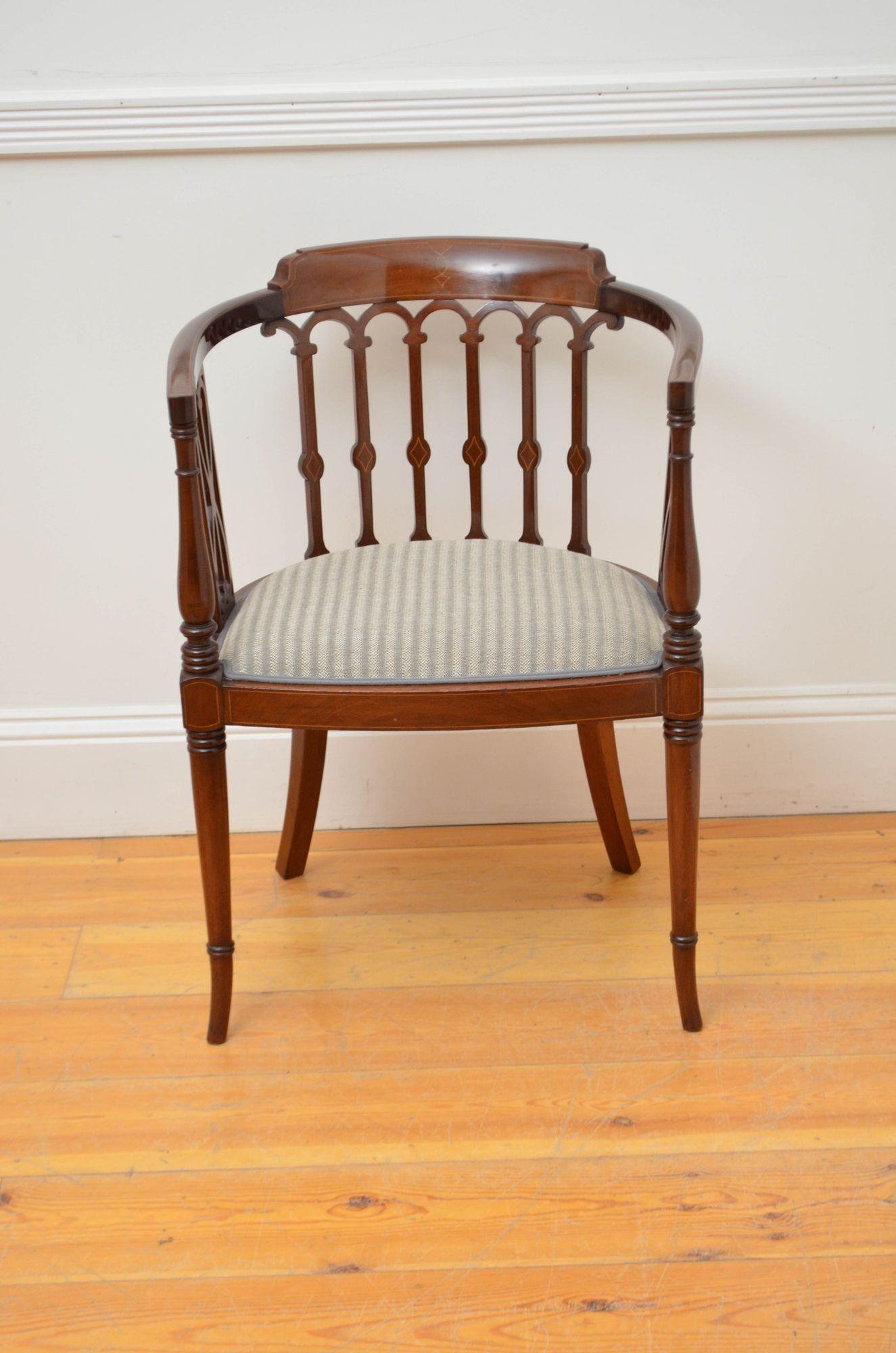 Sn5594 English mahogany occasional chair with string inlaid top rail supported on carved and inlaid uprights, newly upholstered seat and turned and ring outswept legs. This antique armchair is in home ready condition. c1900
H30.5