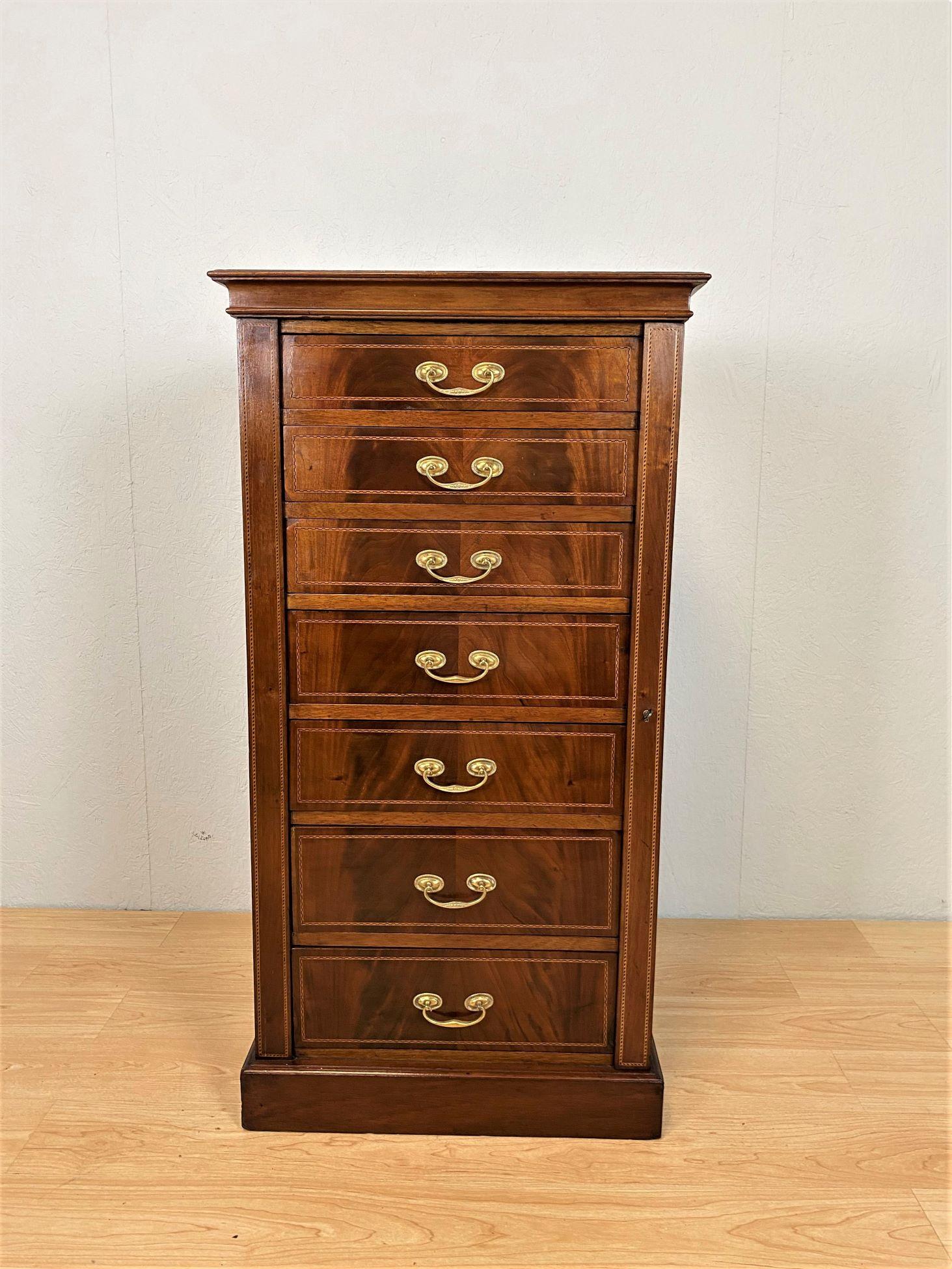 An Edwardian mahogany Wellington chest consisting of seven graduated oak lined drawers each furnished with a brass swan-neck handle.
The swinging locking arm enabling all the drawers to be locked with a single key.
The whole with geometric line