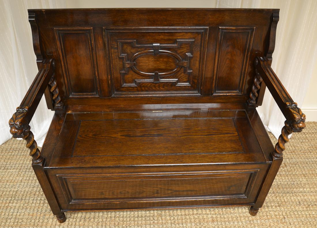 Quality Edwardian Maple & Co. carved oak bench

This quality Edwardian Maple & Co. carved oak bench dates from circa 1910 in the Edwardian period. It has a molded back that folds into a table top if required, sitting above a lift up lid with ample