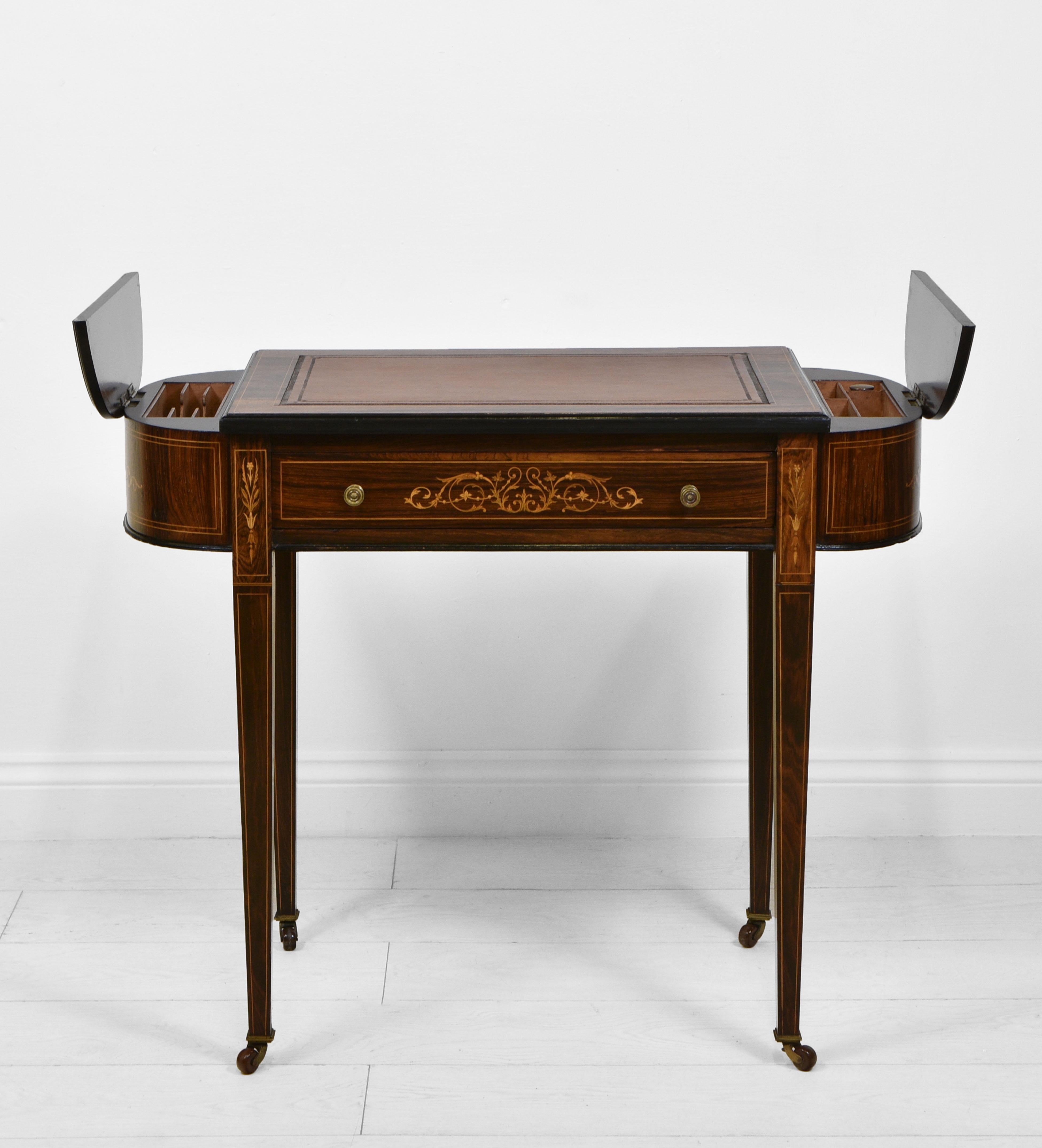 A excellent quality Edwardian rosewood and marquetry inlaid ladies desk, with leather and tooled inset and compartments. Stamped 'Maple & Co Ltd'. Circa 1900s.

The desk's D ends each have a lift up compartment lined in mahogany, ideal for storing