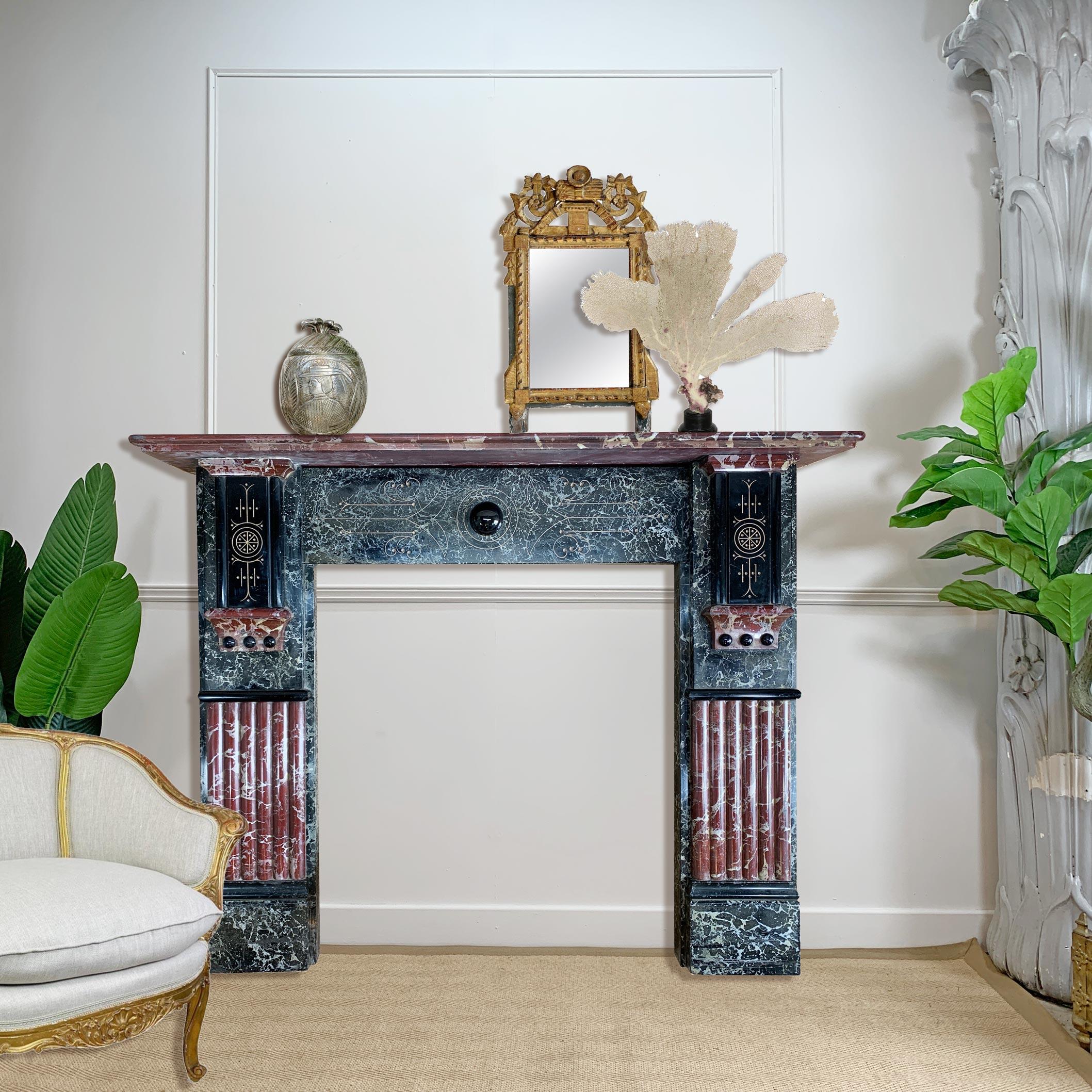 An outstanding marbleised slate fireplace, dating to the late Victorian/Early Edwardian period of circa 1900-1905, the slate hand crafted and shaped, before the application of the decorative rouge royal red and black hand marbling effect. 



The