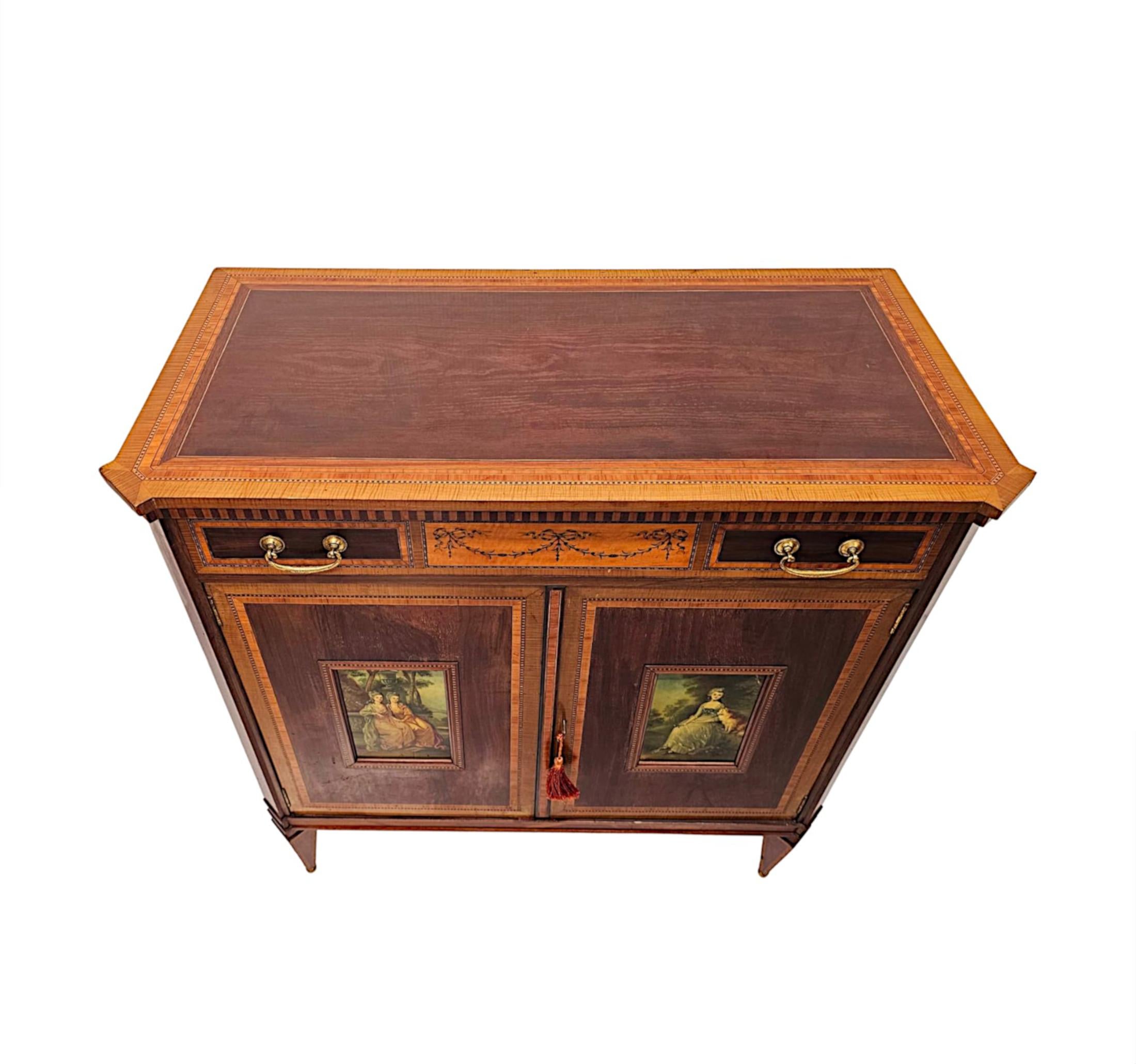 A fabulous Edwardian cabinet in the manner of 'Edward and Roberts' London.  This exceptional piece is finely carved and of fantastic quality with rich patination, fine grain with cross banding, line inlay and stunning marquetry detail depicting