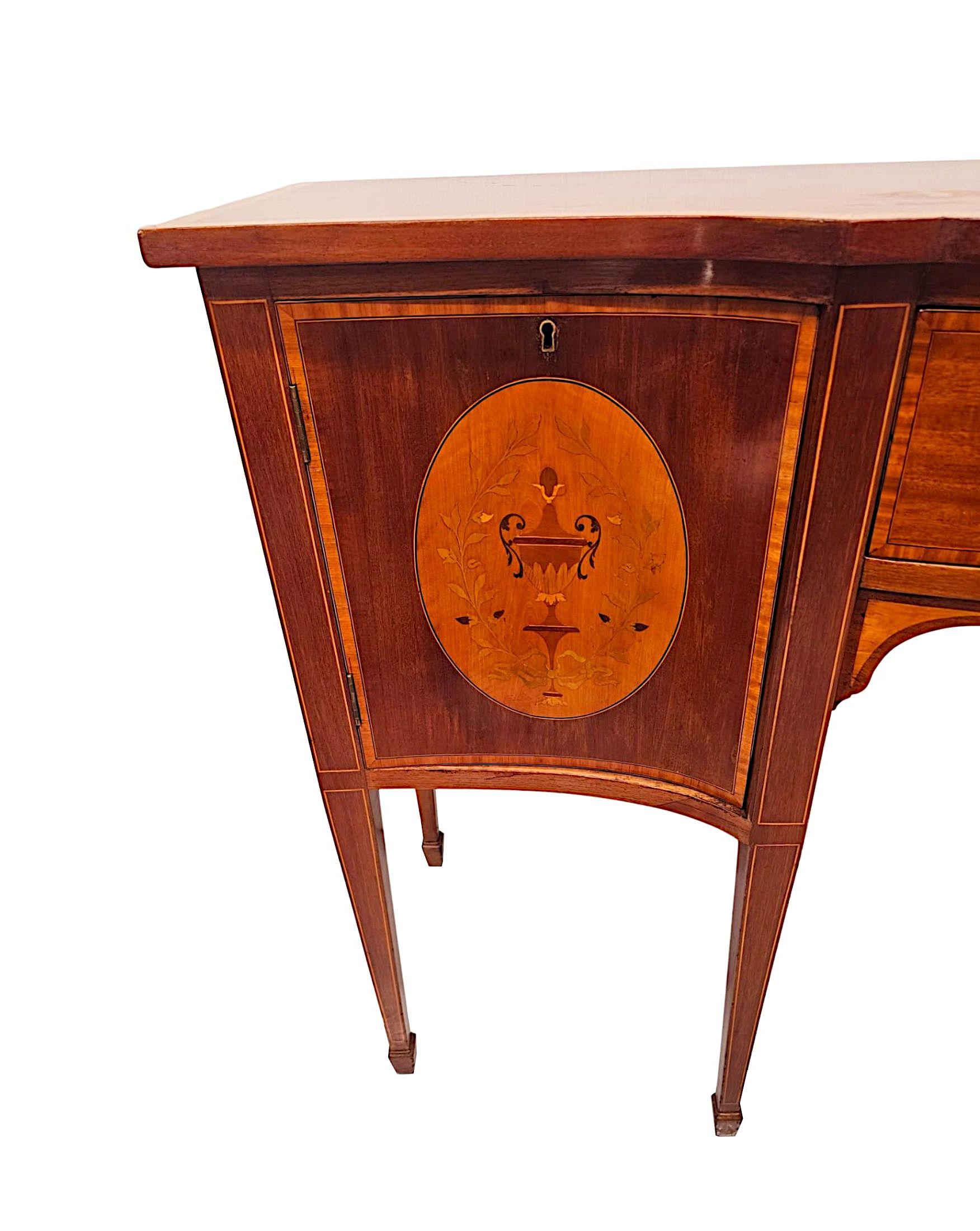 A stunning Edwardian mahogany bowfront sideboard in the manner of 'Edward and Robert's', London.  This exceptional piece is finely carved with beautifully rich patination, grain and crossbanded, line inlaid with fabulous marquetry panels depicting