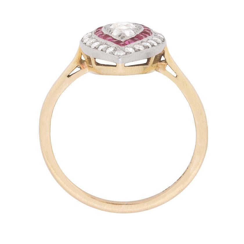 This unique ring features three centre old cut diamond set vertically. They have a combined weight of 0.35 carat and are all hand cut diamonds. They are G in colour and VS in clarity, which are beautifully haloed by rubies. They are set in the