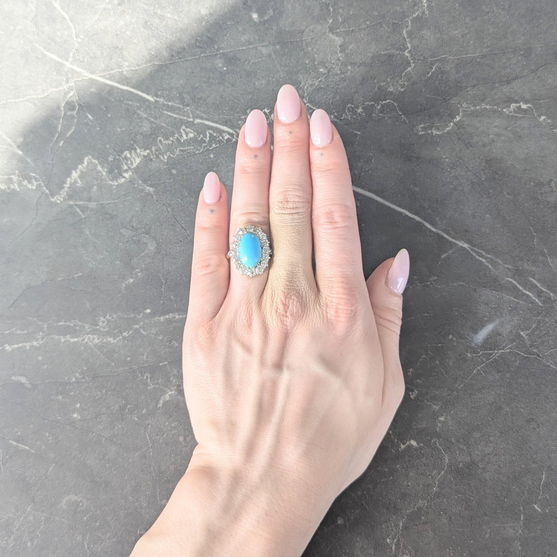 Centering an oval shaped turquoise cabochon measuring 9.5 x 15.0 mm
Opaque robin's egg blue in color with come greenish blue zoning
Set with gold talon prongs and a platinum diamond halo surround
With additional diamonds bead set in shoulders
Old