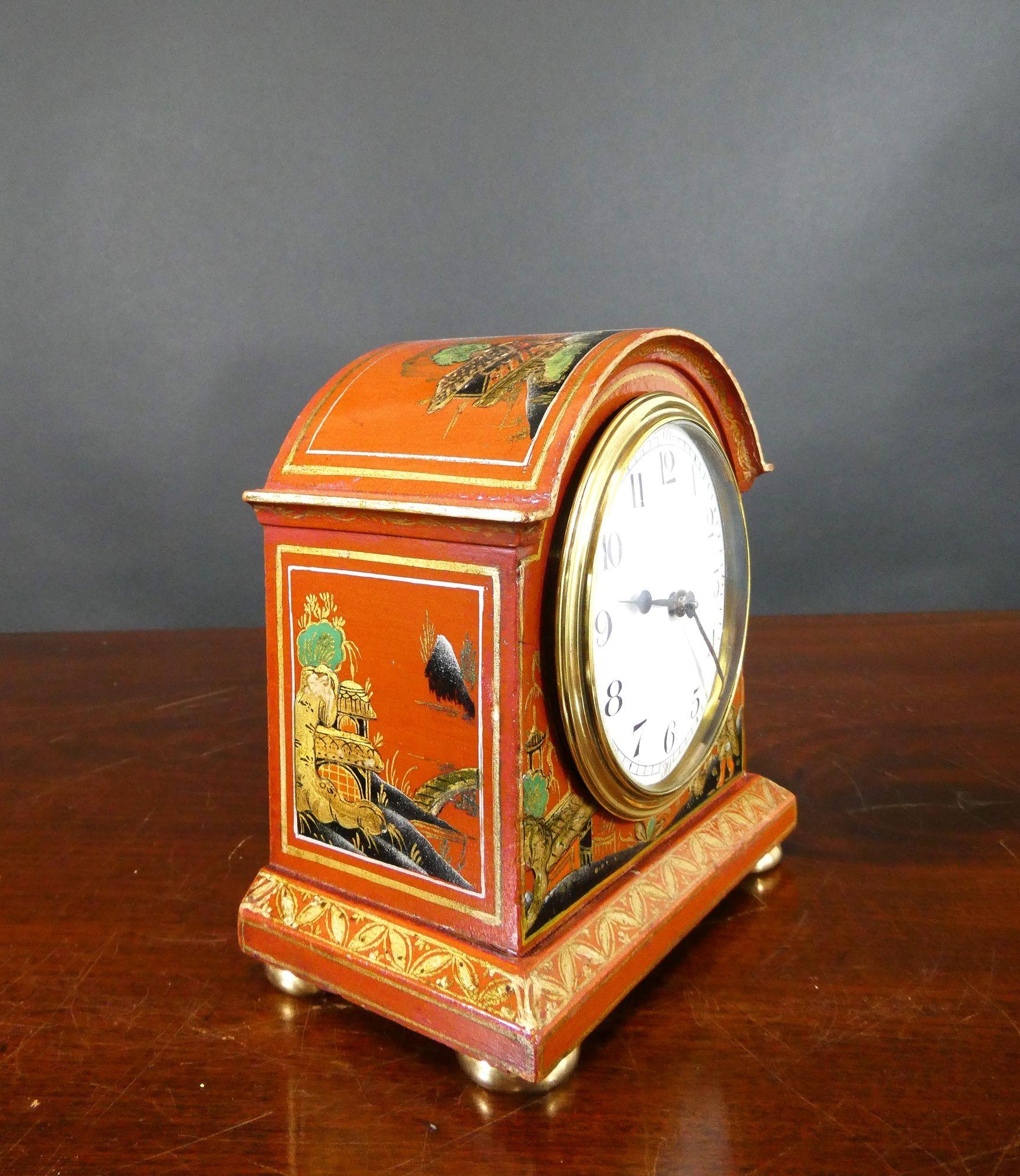 Miniature Chinoiserie Decorated Mantel Clock

Miniature mantel clock housed in a break arch case with raised chinoiserie scenes on a red ground. Stepped moulded plinth with gilded decoration and resting on four brass bun feet, brass bezel with