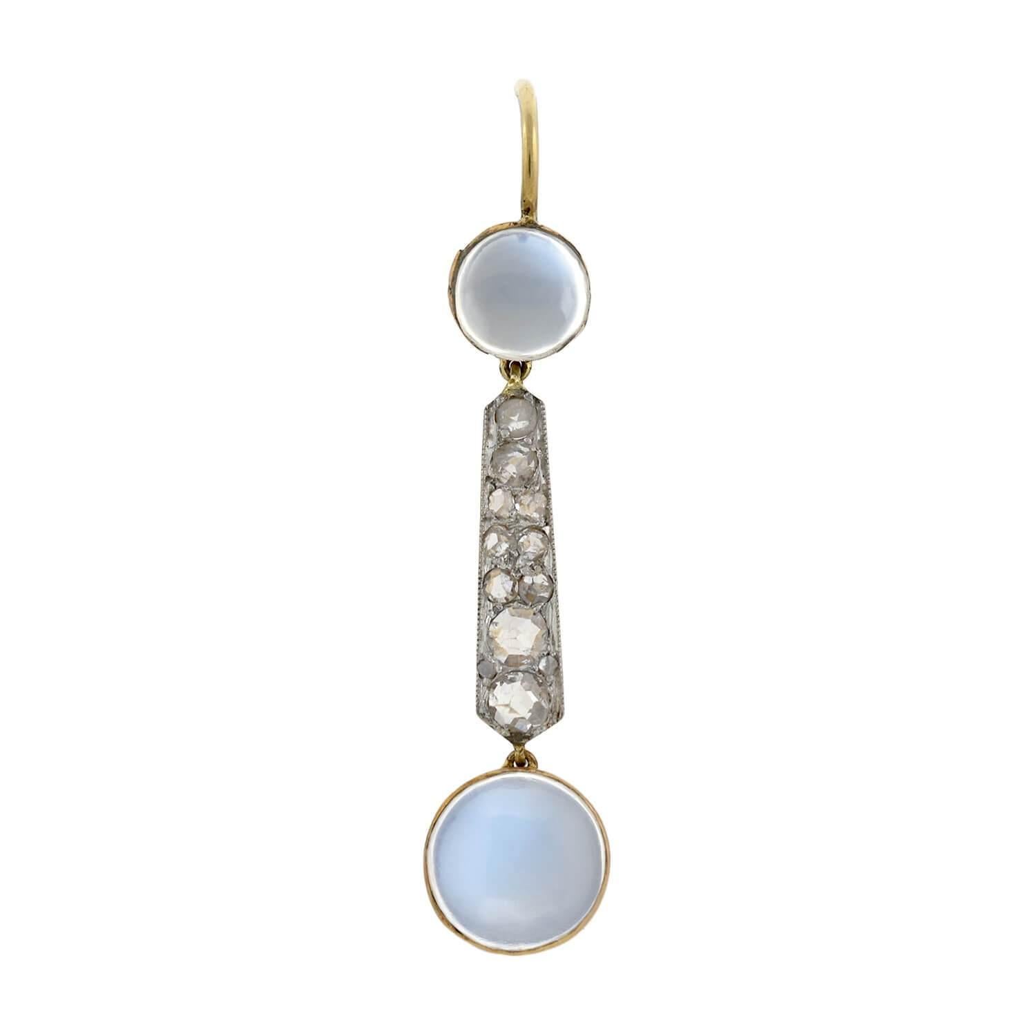 A gorgeous pair of moonstone earrings from the Edwardian (ca1910) era! These stunning earrings are crafted in platinum topped 14kt yellow gold, and have a dramatic elongated drop design. A round, bezel set moonstone cabochon rests at the top, and