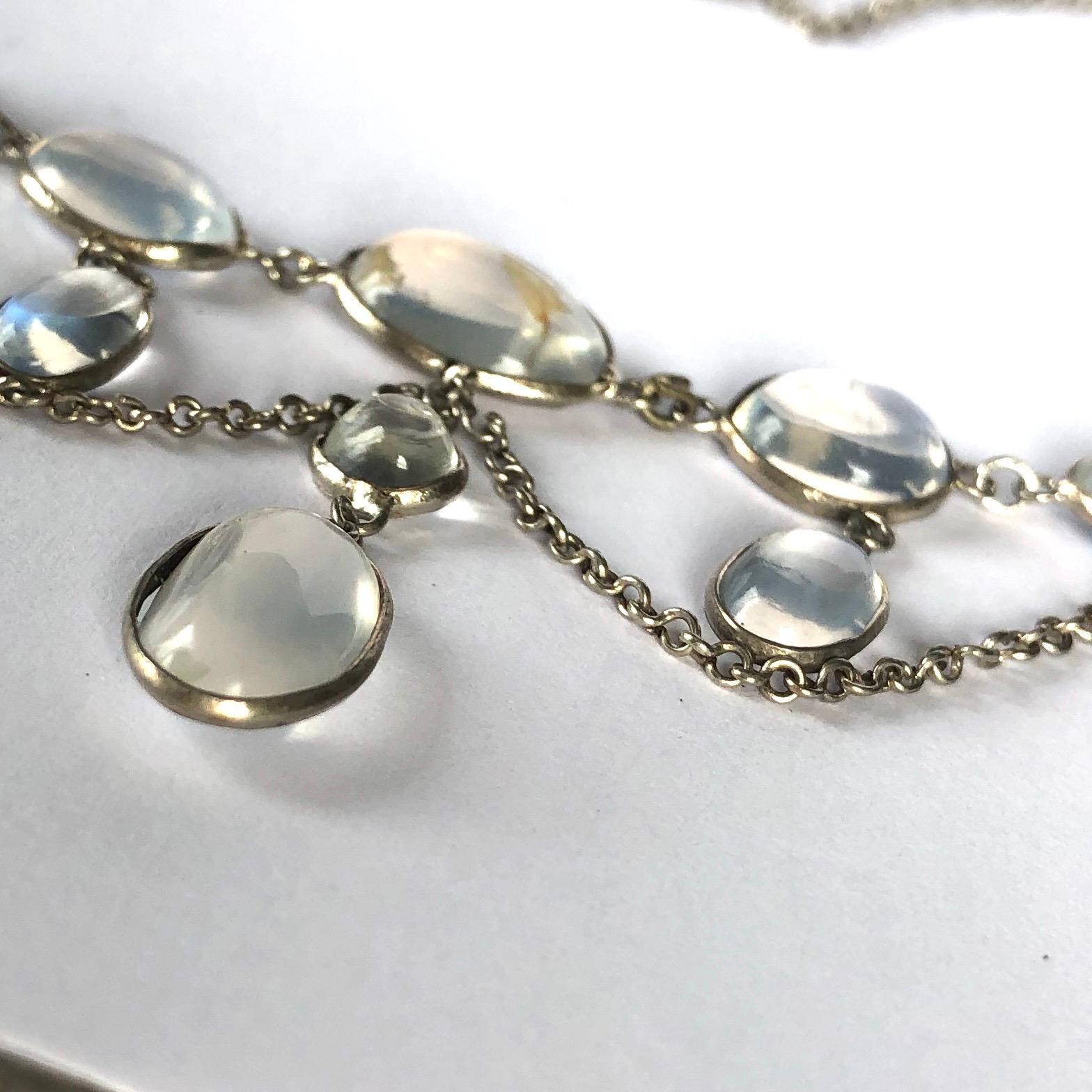An exquisite Edwardian festoon necklace. The chain is set with oval moonstone cabochons and small drops within the elegant swags.

Chain Length: 36.5cm
Drop Length: 37mm

Weight: 6.8g