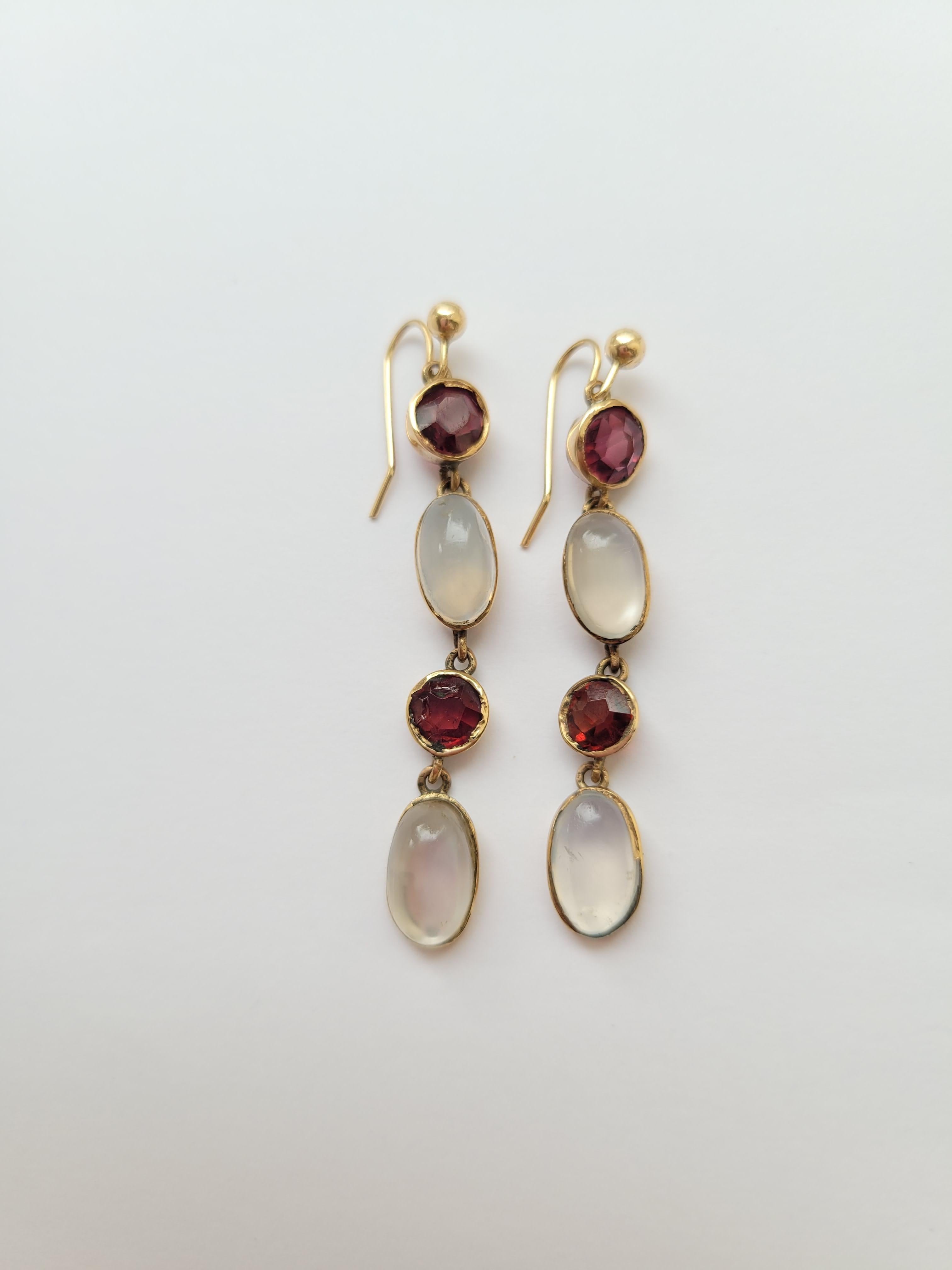 A pair of Antique Edwardian circa early 1900s 9 Carat Gold, Moonstone and Garnet drop earrings. Earrings completed with a brand new 9 Carat Gold shepherd hook wires. English origin. 

Total drop including hooks 47mm.
Weight 4.0gr.
Unmarked tested,
