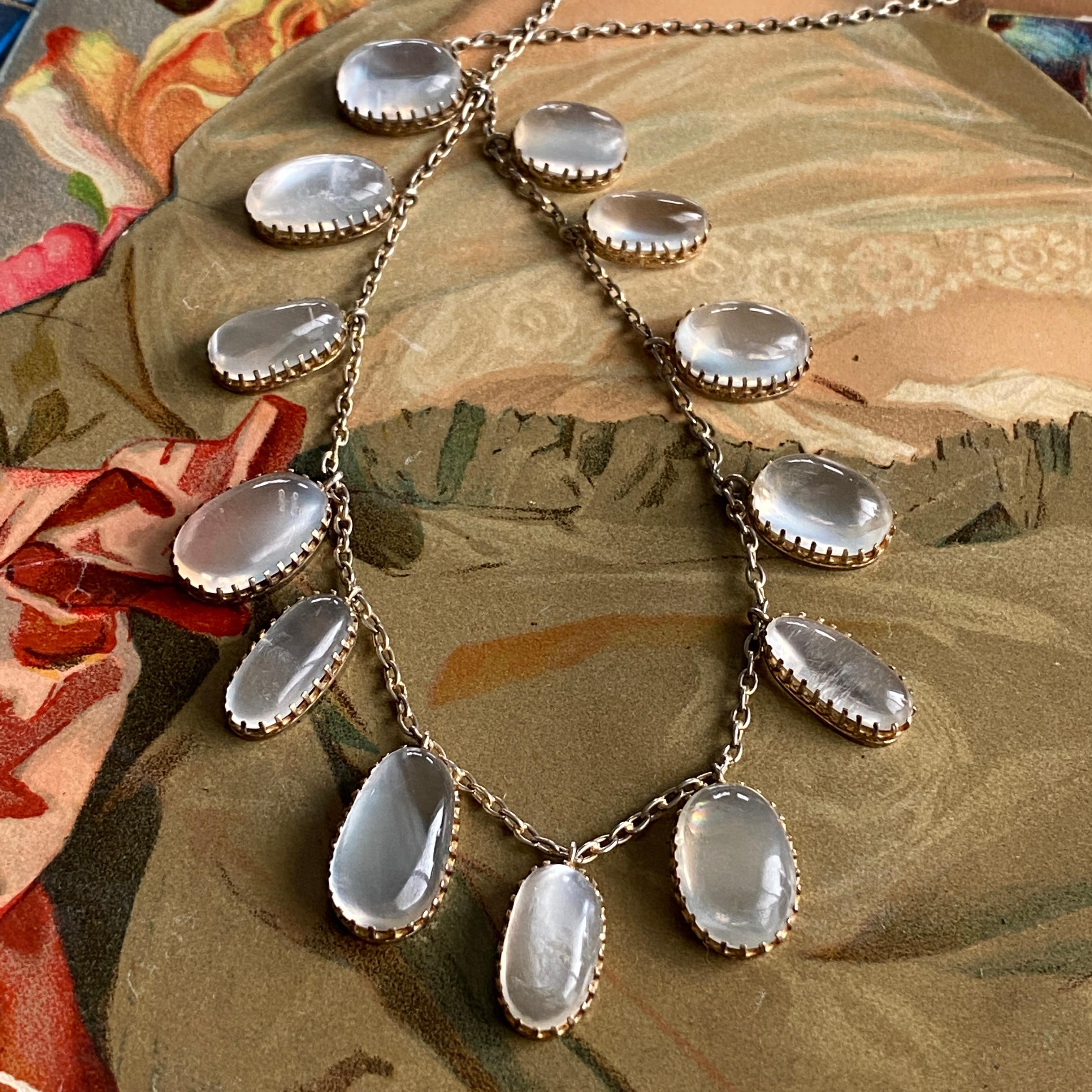 Details:
Full of charm! Sweet Edwardian Moonstone festoon necklace set in silver gilt. This necklace has feminine silvery gold chain with irregular natural cabochon graduated moonstone drops. The settings on the stones are beautiful, and detailed