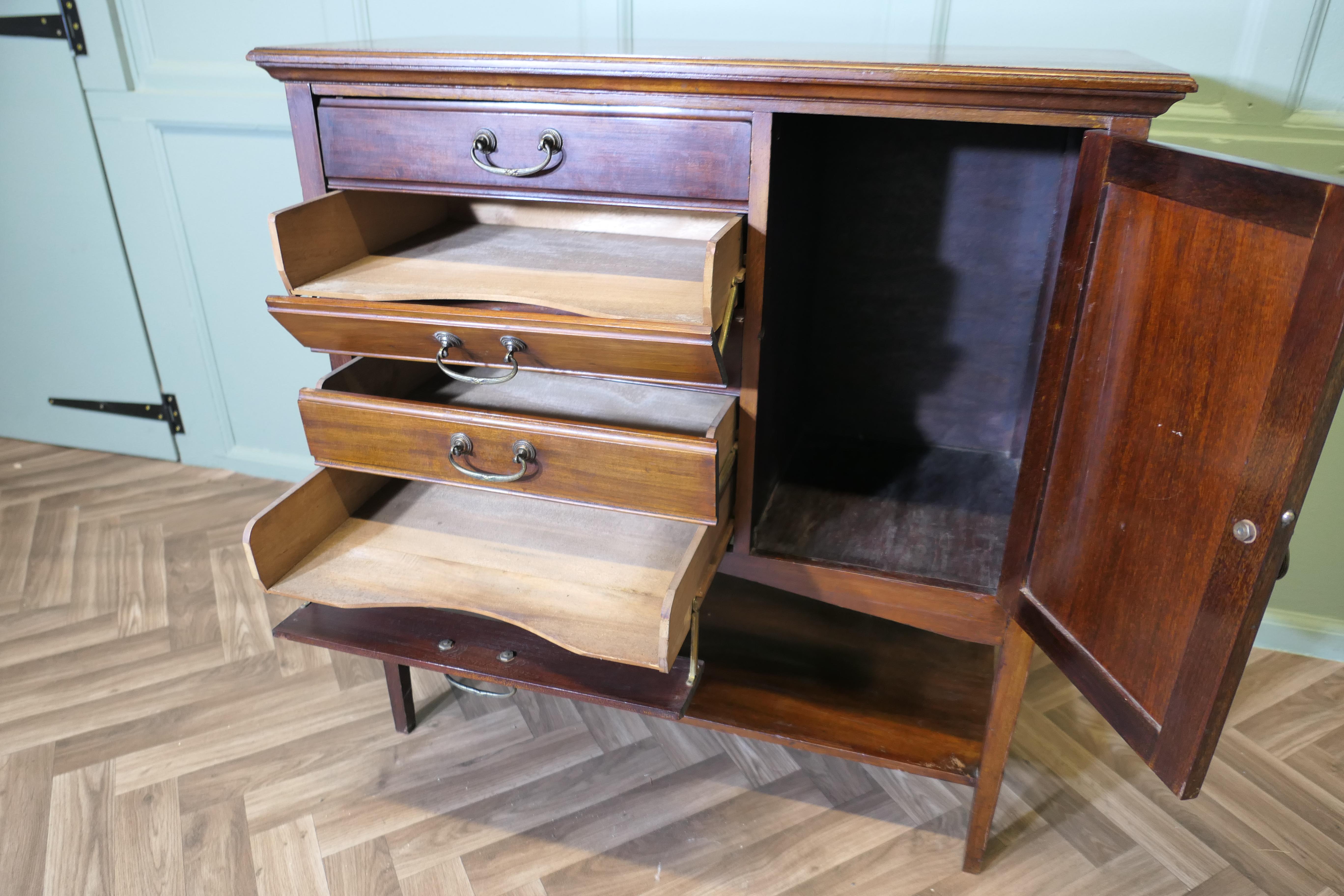 Edwardian Music Cabinet

A good looking piece, the cabinet has 5 slides or drawers with fall fronts for the storage of sheet music and a cupboard on the right hand side under these there is an under shelf
The cabinet is in good antique condition, it