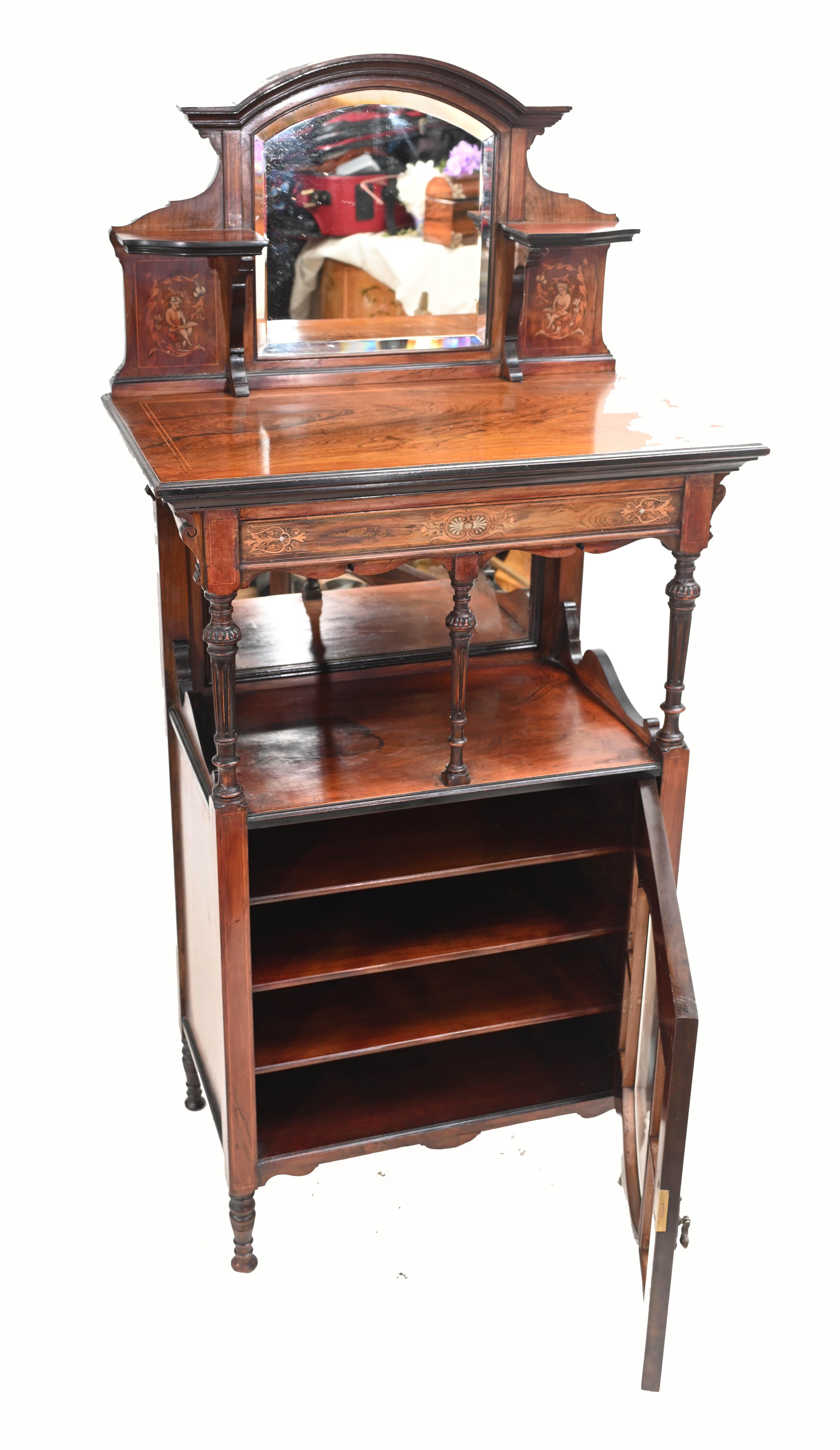 Elegant Edwardian music cabinet in rosewood 
We date this to circa 1910 
Features intricate marquetry inlay work including distinctive cherub panels 
Some of our items are in storage so please check ahead of a viewing to see if it is on our shop