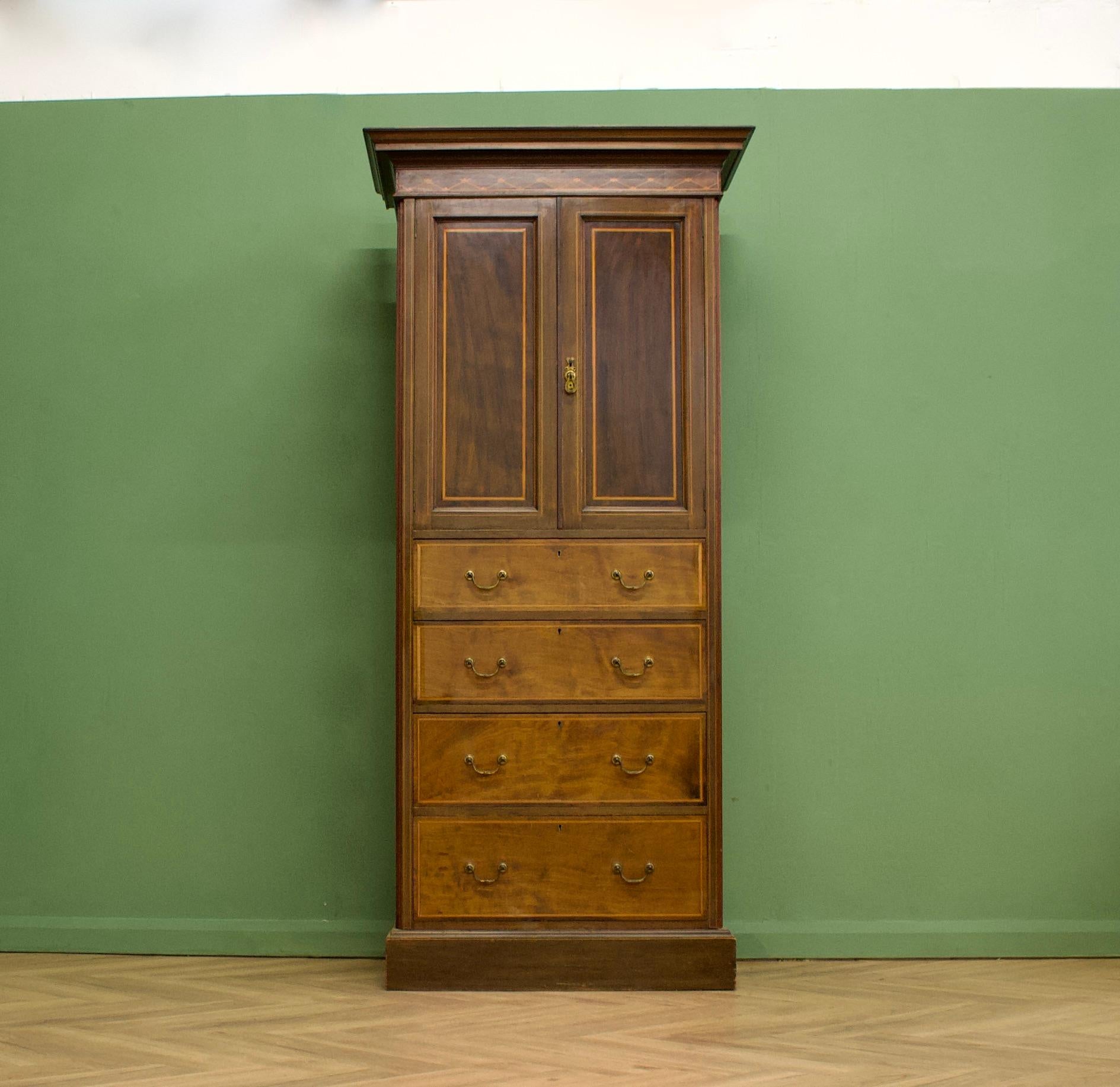 A tall, narrow Edwardian linen cabinet or hall cupboard

To the top there is a cupboard with two pull out drawers
To the bottom is four generous sized drawers