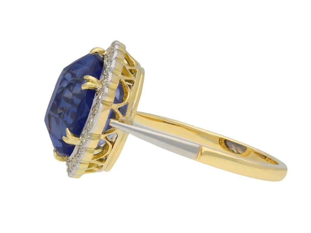 Edwardian Ceylon sapphire and diamond coronet cluster ring. Centrally set with a round old cut natural unenhanced Ceylon sapphire in an open back split fancy claw setting with an approximate weight of 10.20 carats, encircled by a single row of