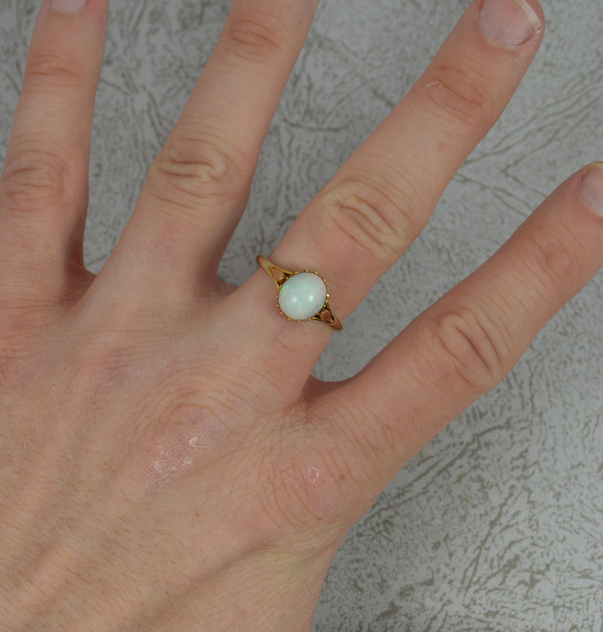 A fine opal and diamond ring, circa 1910.
Solid 18 carat yellow gold example.
Set with a single natural, oval shaped opal. 7.9mm x 8.9mm approx.

CONDITION ; Very good for age. Clean and solid band. Well set stone. Issue free. Please view